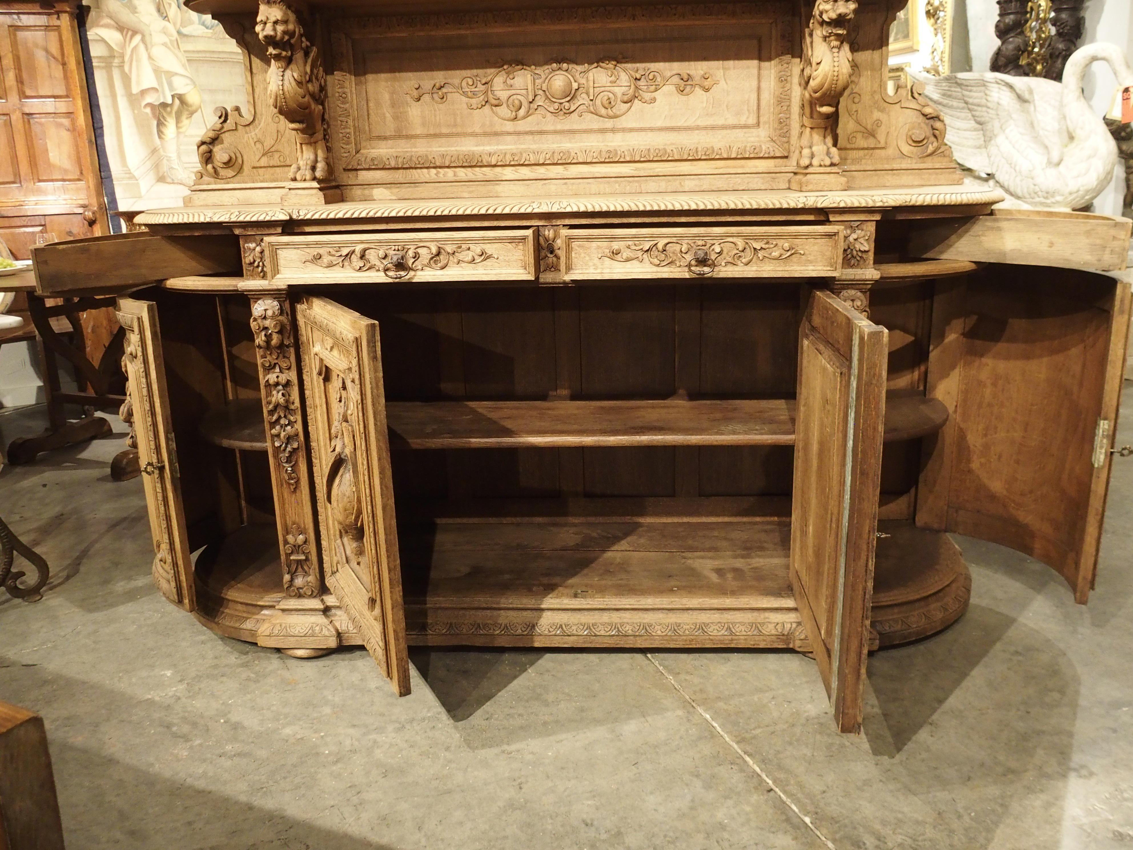 Known as a “St Hubert”, this impressive oak hunt buffet features a well-carved back wall with two shelves set above a traditional buffet body. This structure, as well as the presence of the highly detailed and scrolled pilasters, are hallmarks of a