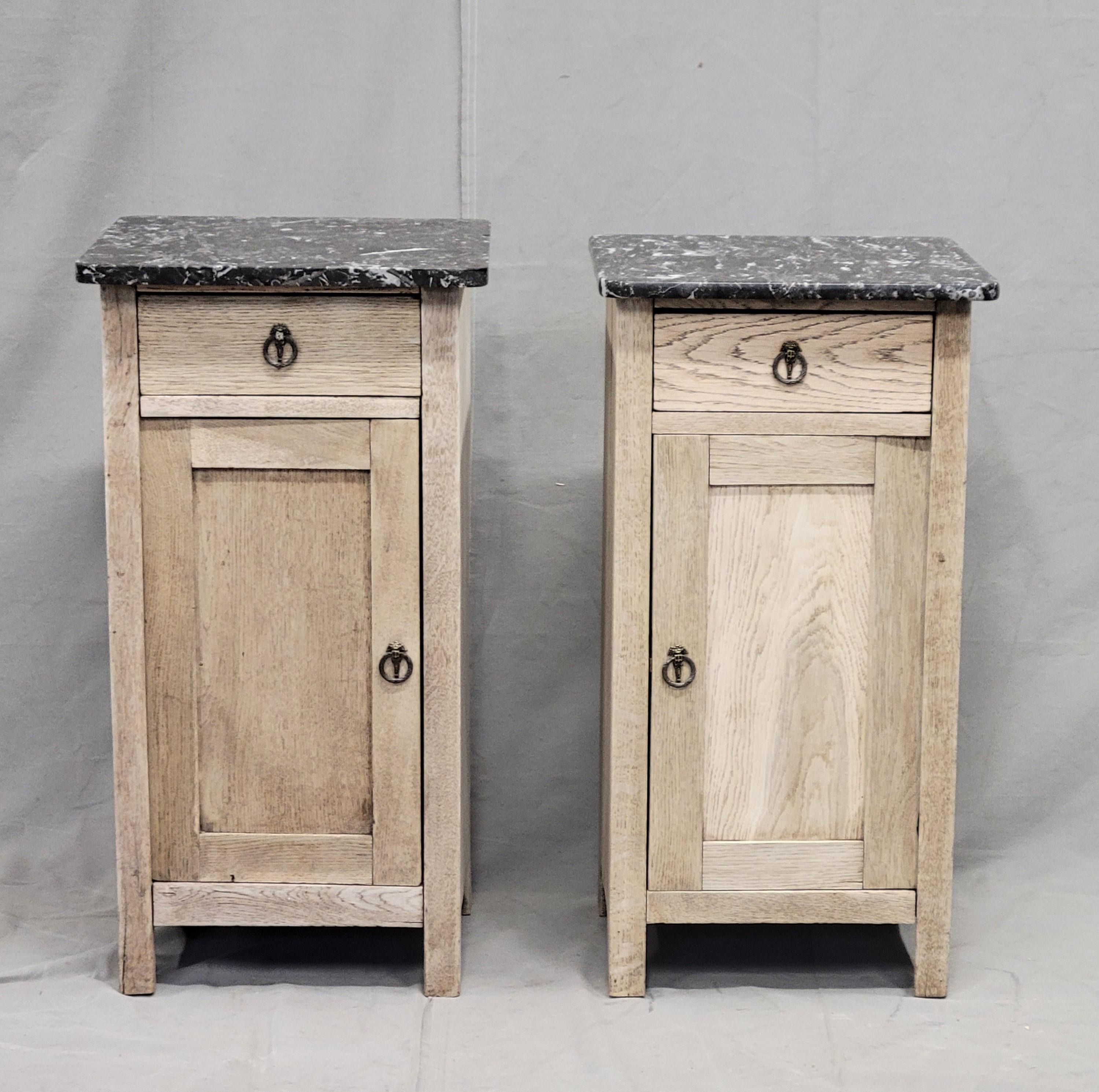 A sophisticated near pair of bleached oak French nightstands with black honed marble tops will add rustic elegance to a bedroom.
Condition commensurate with age and use. Antique oak has been bleached. Vintage replacement pulls have been added. An