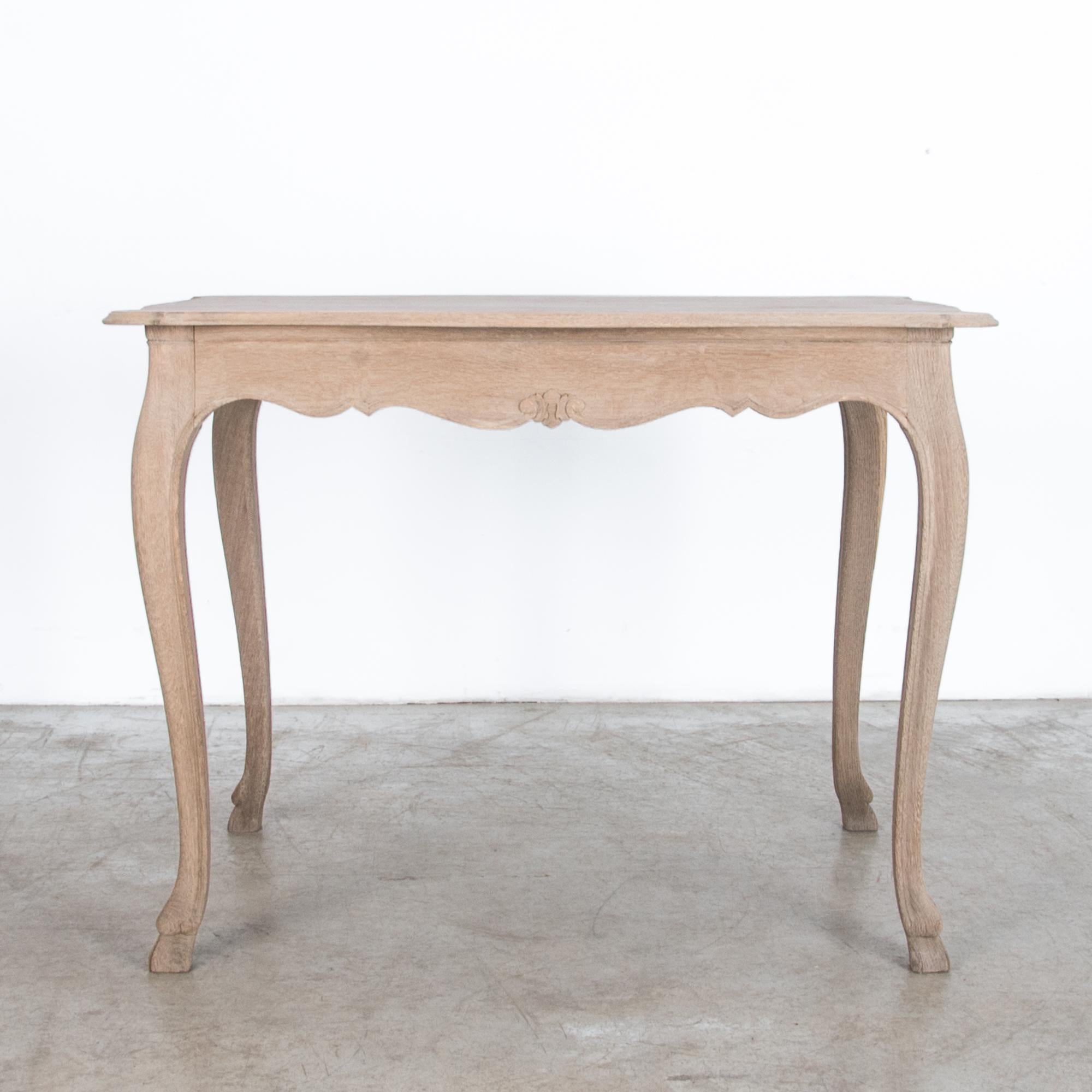 A simple oak table, from France, circa 1900. Rustic yet refined, this oak table is crafted after the traditions of local craftsmen. Away from the capital, carpenters interpreted the latest fashion in pared down styles, recalling their local ambiance