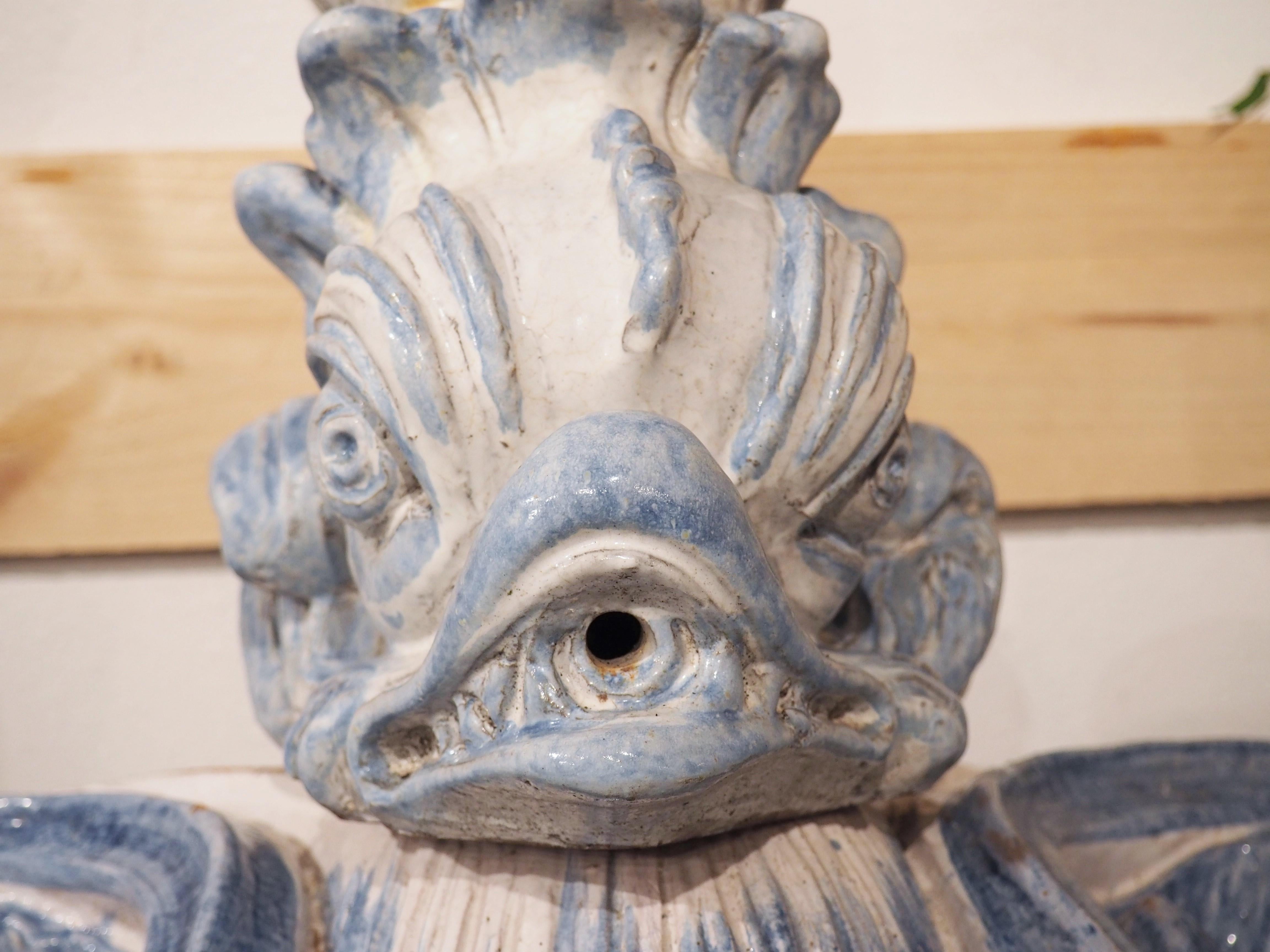 Made from tin-glazed pottery, known as faience, this antique French interior wall fountain is from circa 1880. All three sections that comprise the fountain have been hand painted in cobalt blue and white, reminiscent of Delftware that was popular
