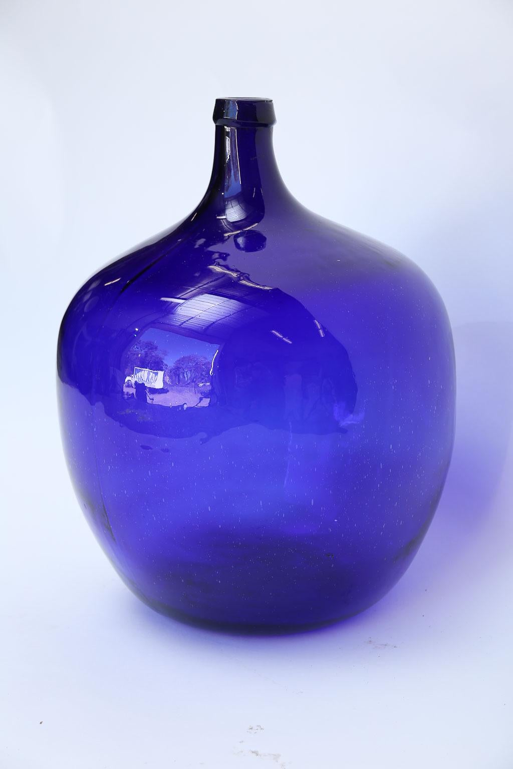 This antique cobalt blue French demijohn will surely add beautiful color to any room.