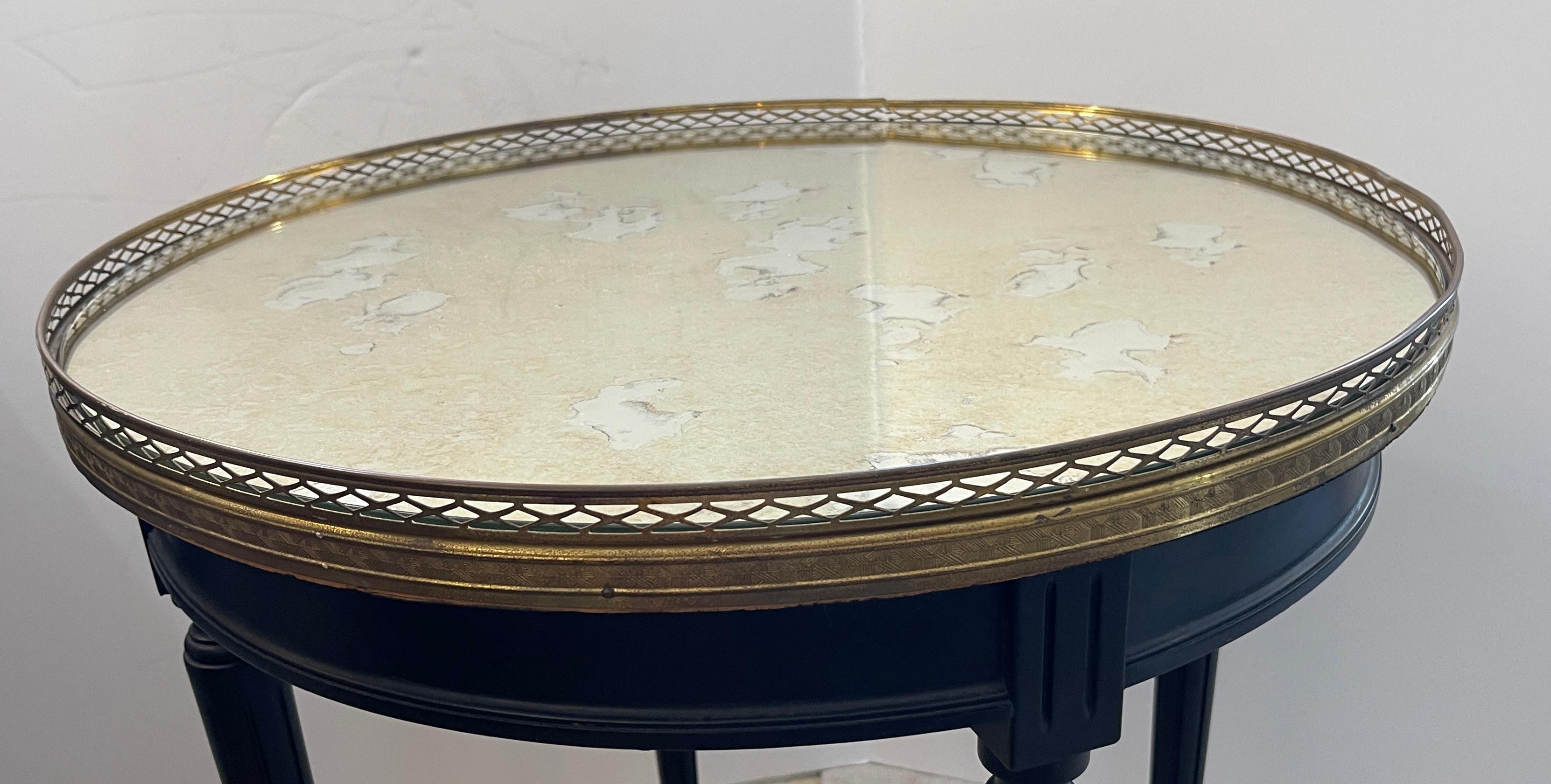 Just imagine, This French Louis XVI style Bouillotte Table, with a perforated  Brass Gallery and antiqued  Mirrored Top.
This is in the  Louis XVI style, c.1920-1940s
This table has the tapered legs 
The mirrored top has been replaced.
Very good