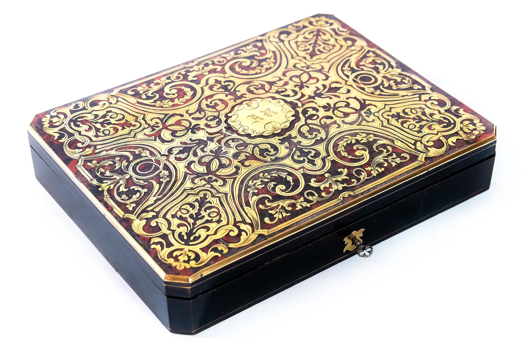 Antique French Boulle marquetry box with game elements inside, cards and bone game chips.
The wooden box is decorated with inlaid brass and tortoiseshell.
Original key is included.
  
