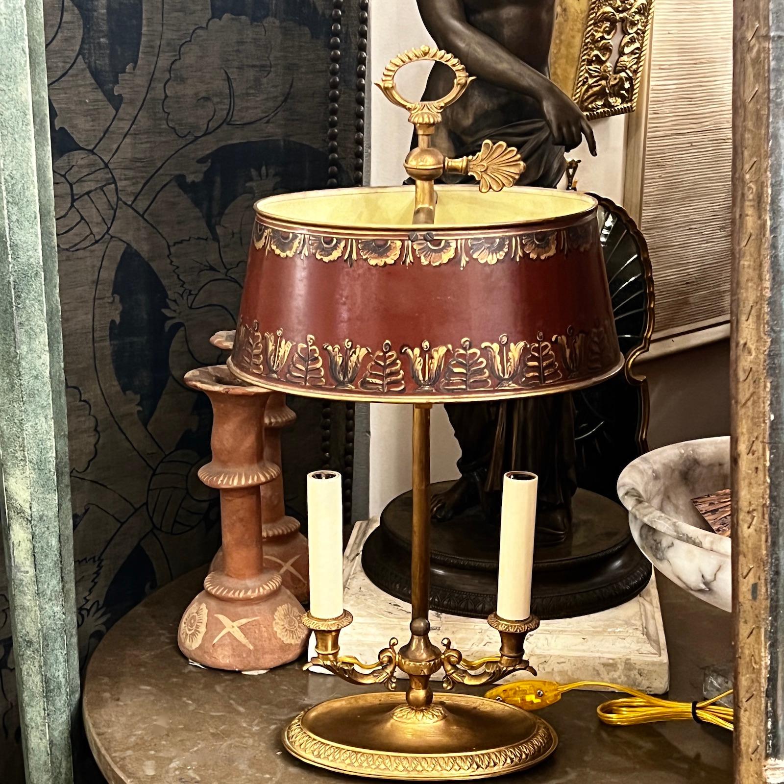 A circa 1910 French bronze desk lamp with original painted shade.

Measurements:
Height: 19.5