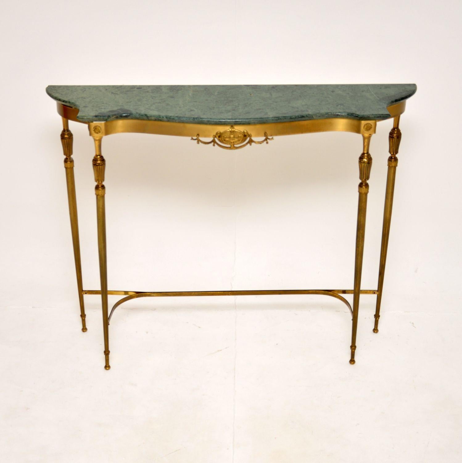 A beautiful and elegant antique French brass and marble console table, dating from around the 1930’s.

It is very well made and has an absolutely gorgeous design. The tapered legs are finely fluted, with lovely embellishments throughout the base.