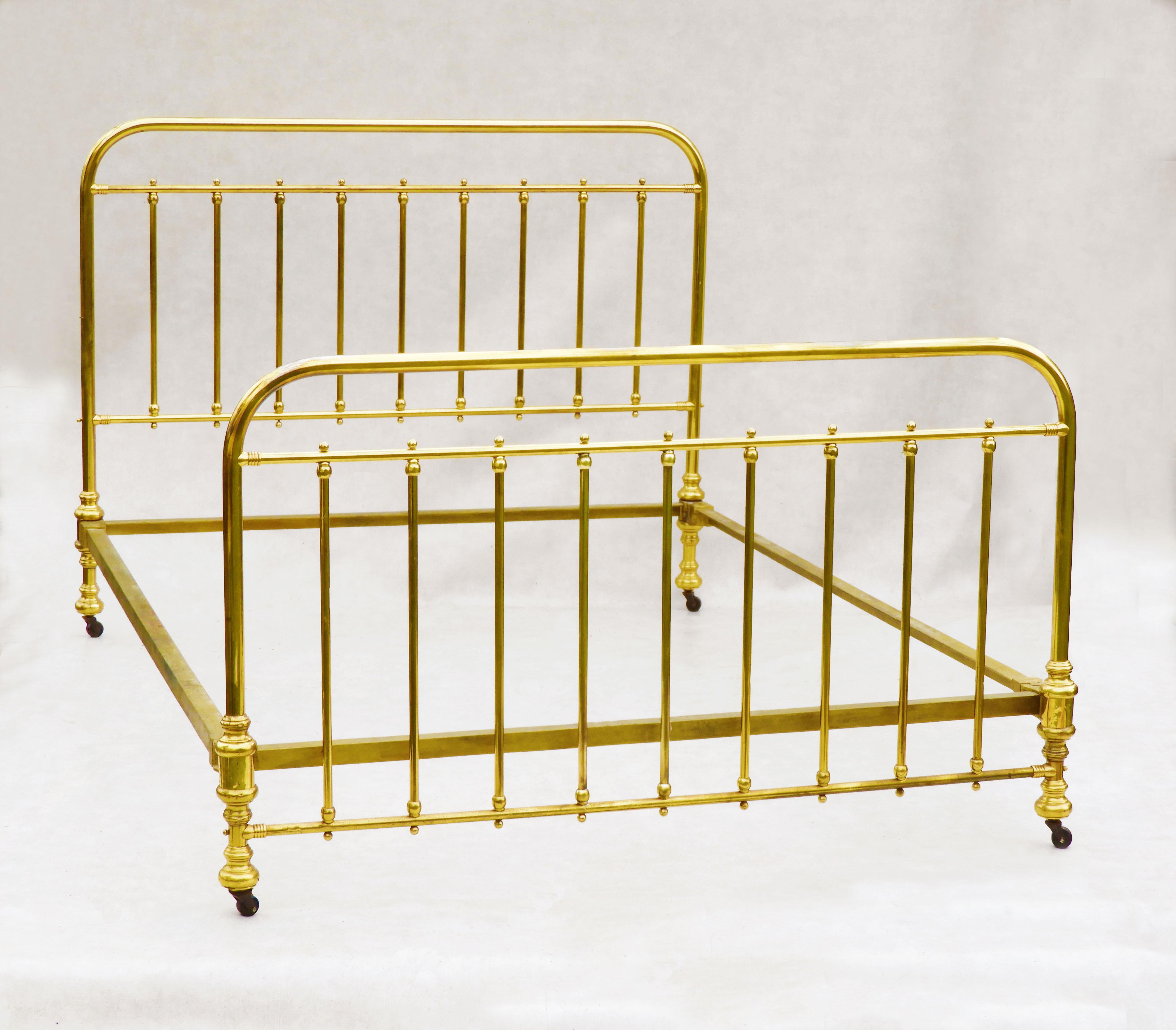 Stylish and unusual French antique brass bed.  Rectangular in form but with smooth rounded corners, tubular rails and ball finials. A good quality well-made bed. In good condition, sturdy and strong with good colour and nice patina, clean but not