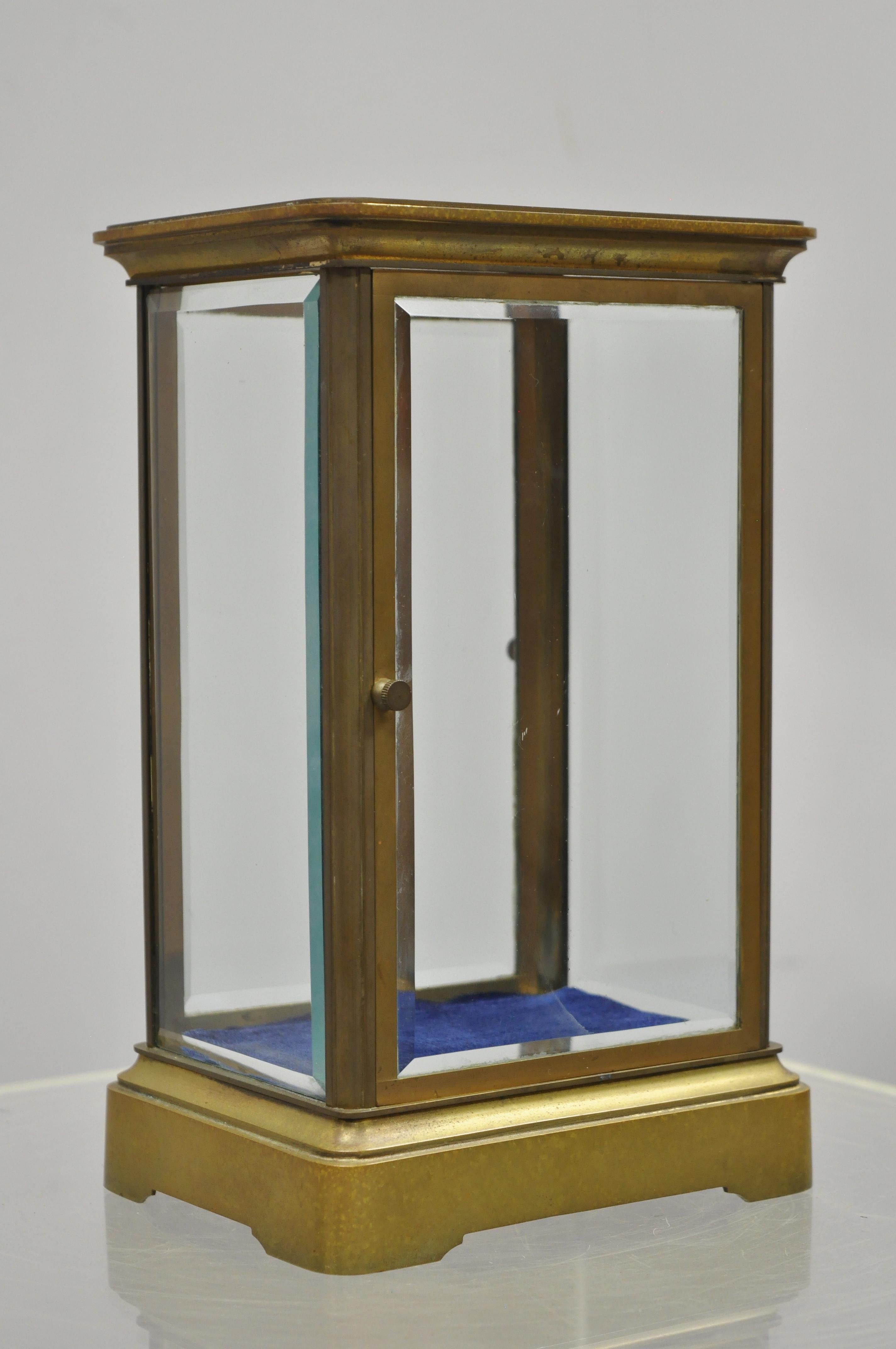Antique French brass bronze glass small carriage clock mini figure display case. Item features double door entry, beveled glass panels, removable blue fabric liner, solid brass construction, remarkable quality and craftsmanship, circa early 20th