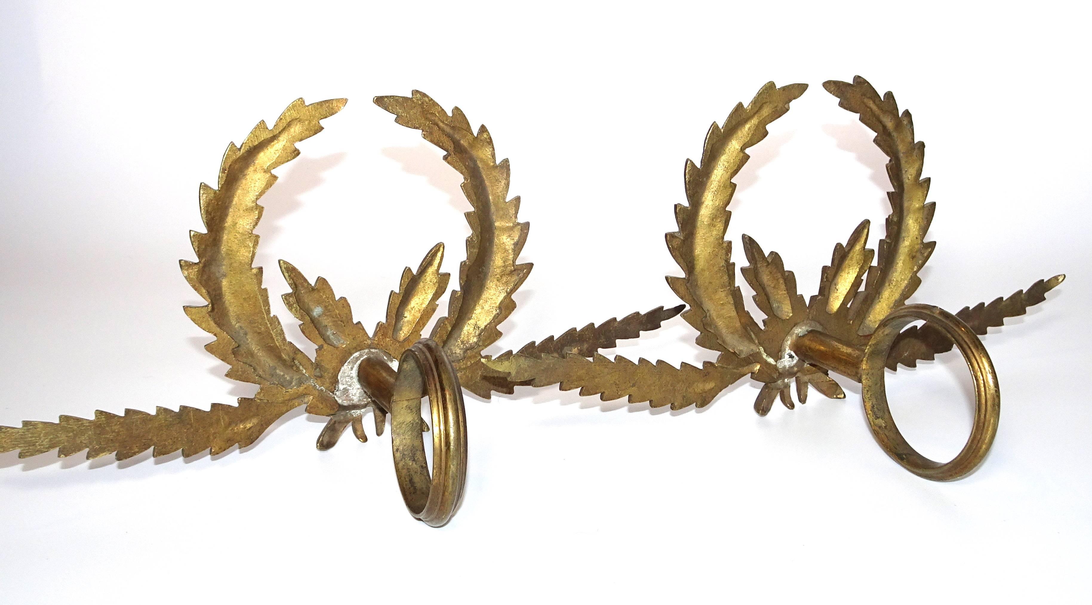 Antique French brass drapery rod holders with garland design.