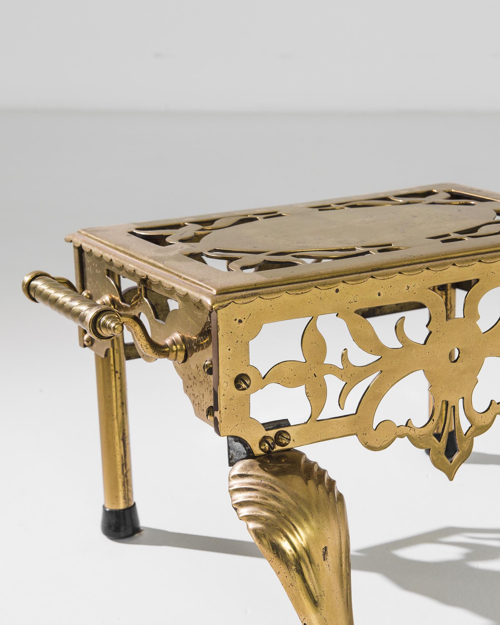 A beautifully crafted antique footstool produced in France, circa 1860. Of Victorian inspiration, this brass creation is as practical as visually pleasing. The two handles allow for easy transportation, while the floral cut outs and cabriole feet