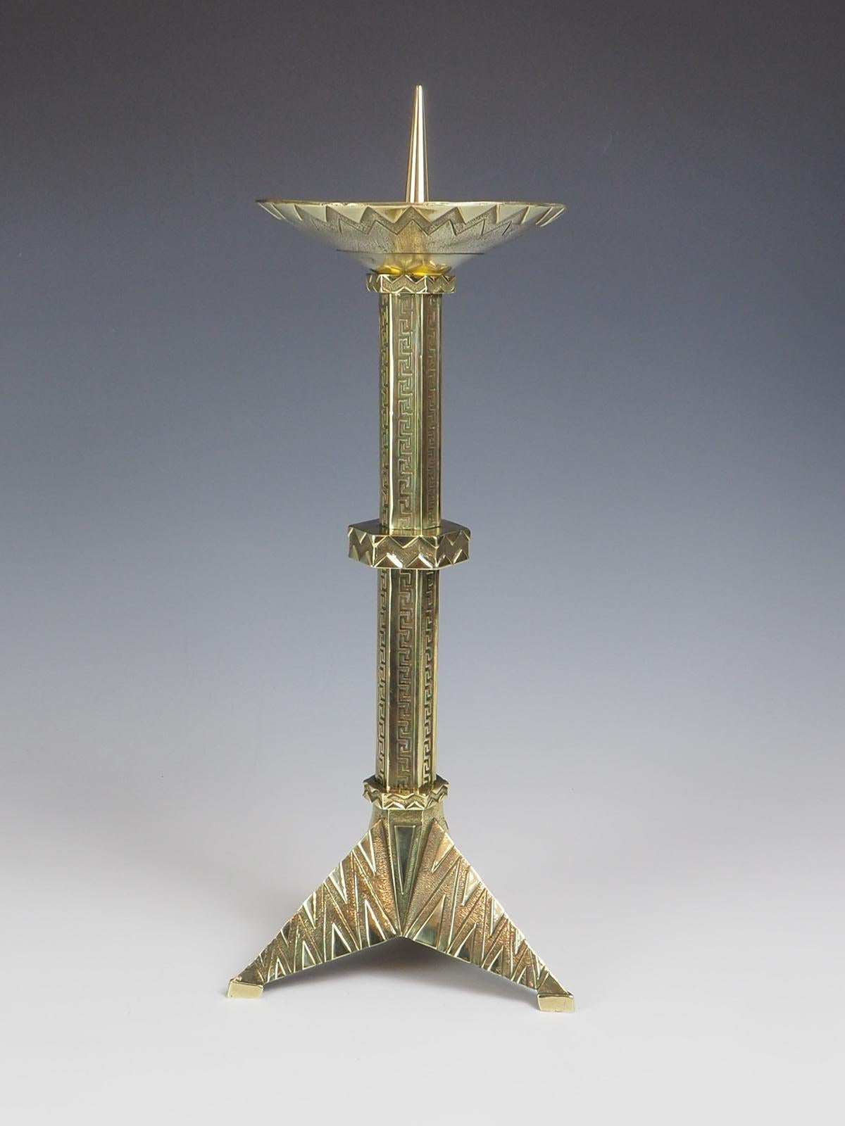 Antique French Brass Geometric Art Deco Pricket Candlestick is a stunning piece that showcases the elegance of the Art Deco era. Made from high-quality brass, it features a unique geometric design that adds a touch of sophistication to any