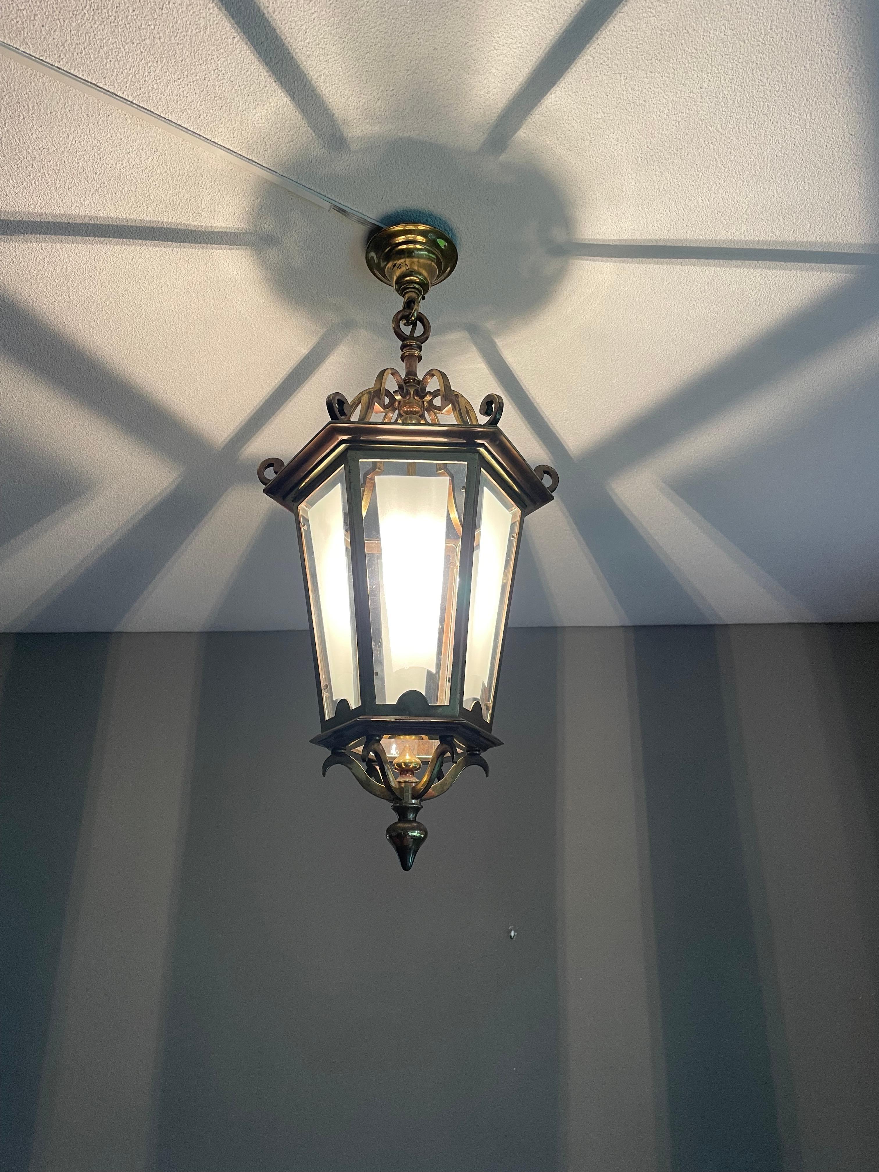 Good size, great condition brass hallway pendant with unique art glass.

If you are looking for a stylish and quality crafted antique lantern to grace your entry hall, stairwell or landing then this quality made and relatively timeless light could