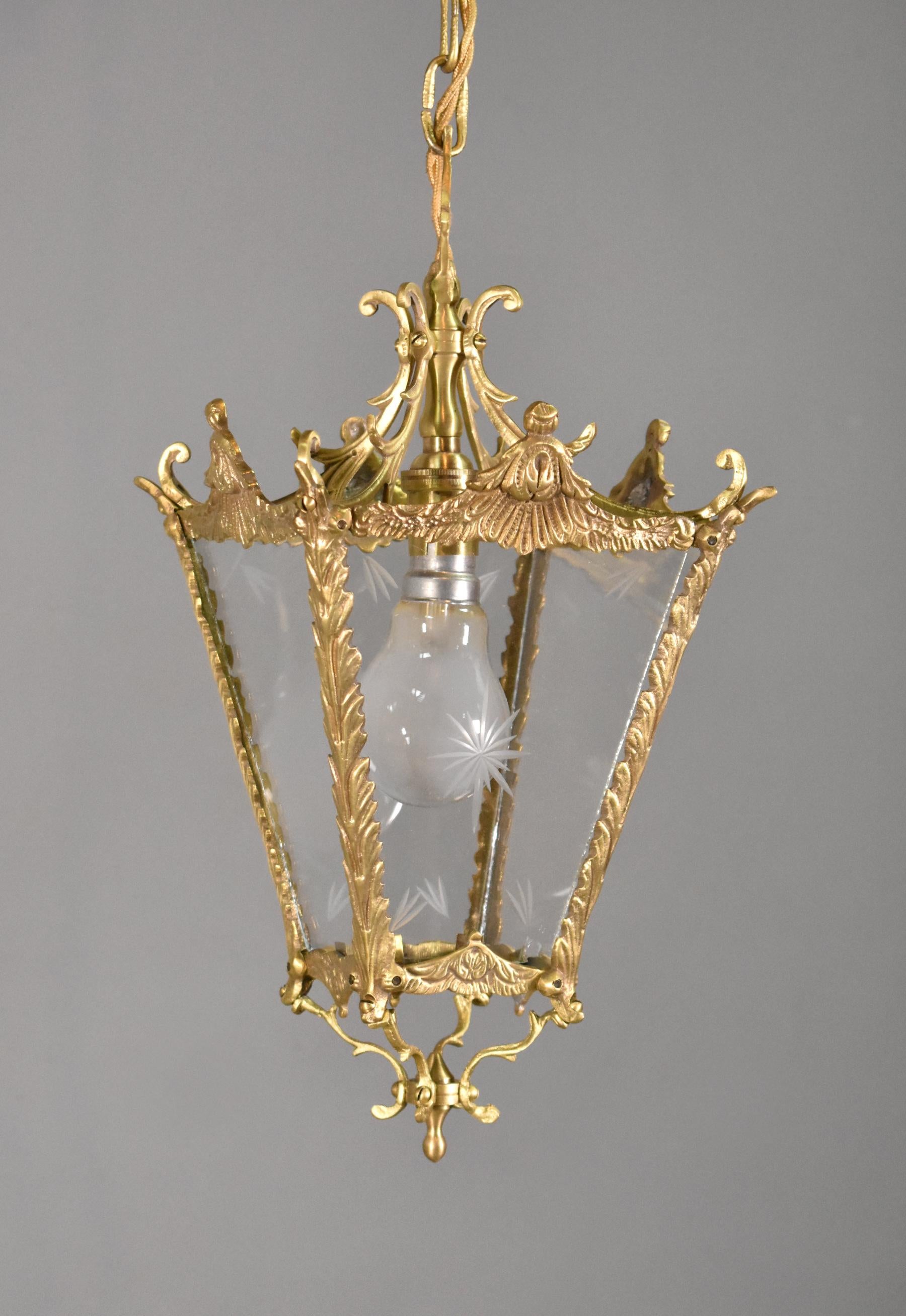 Antique French Brass lantern Louis XVI Style 

This pretty lantern has a single bayonet bulb suspended from a decorative cast ceiling rose and gilt chain which can be adjusted for height. 

There are four clear glass panels, two of which are