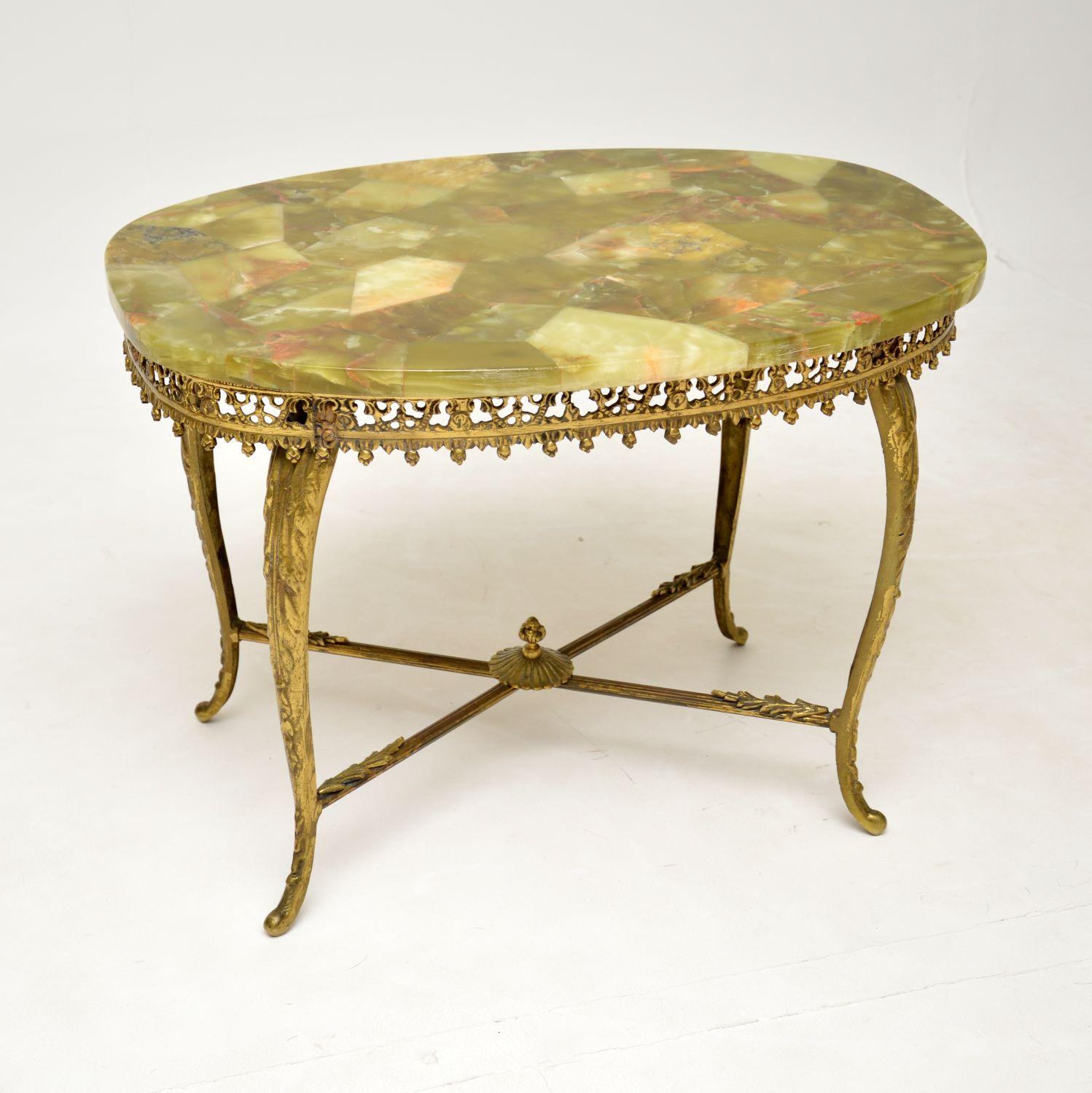 A beautiful & very stylish antique French coffee table in solid brass and onyx. This was made in France, it dates from around the 1930’s.

The quality is fantastic, with a stunning and intricate pierced brass frame. The onyx top is also stunning,