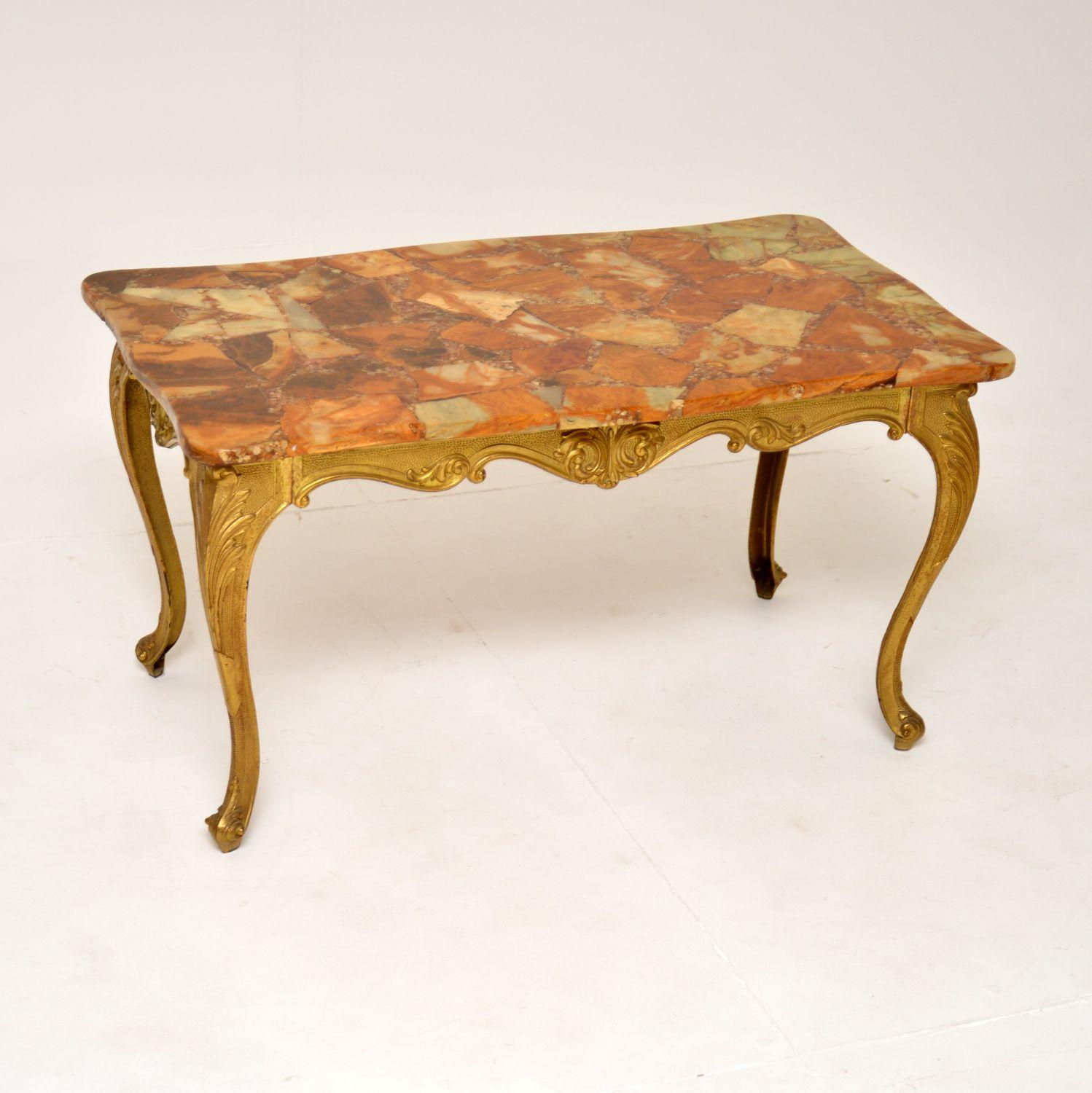 A beautiful antique coffee table with a fine quality solid brass frame and onyx top. This was made in France, it dates from the 1930-50’s.

It is very well made, the brass frame has a gorgeous shape and very fine details. The onyx top is quite