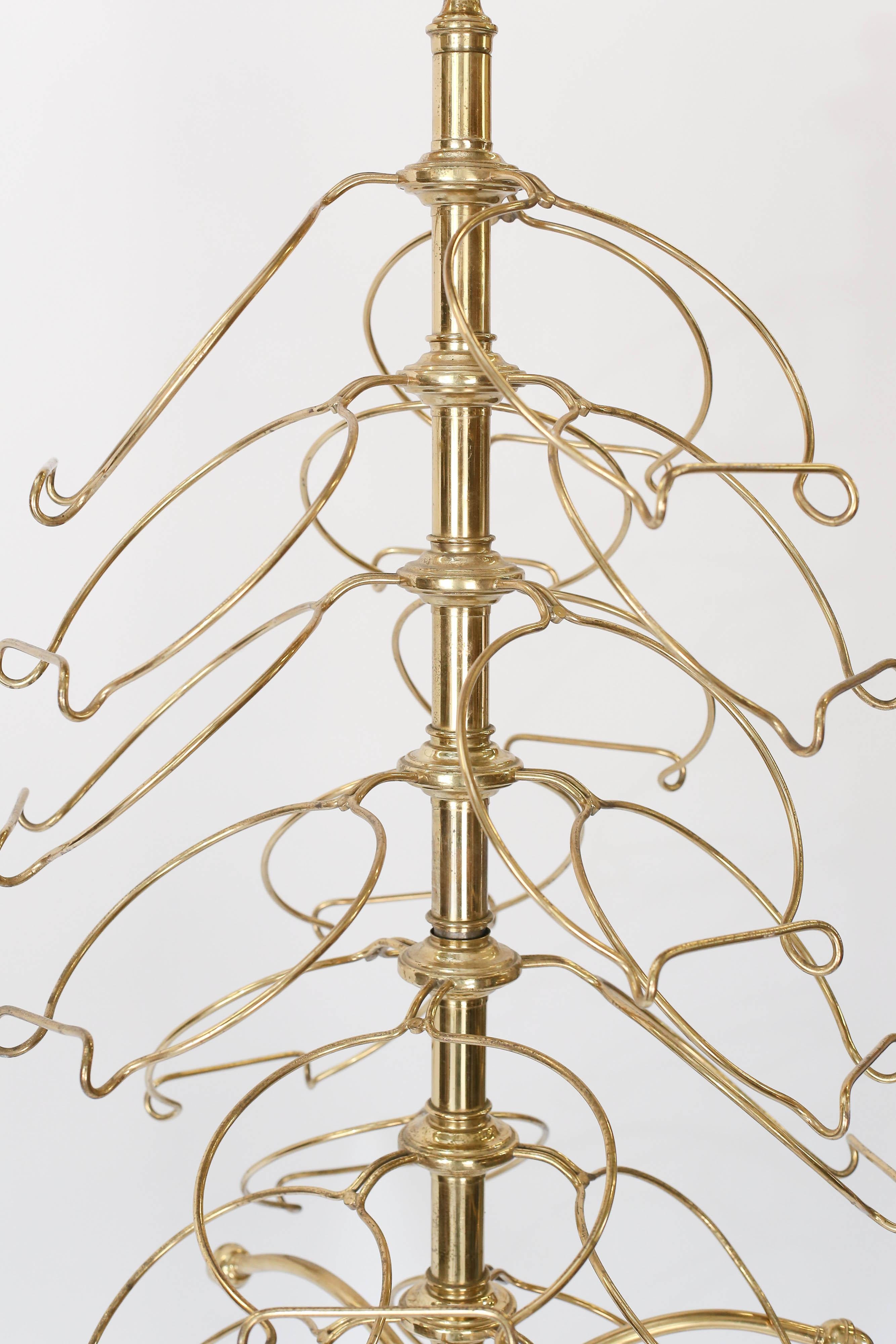 Found in France this brass plate holder holds 36 plates. Standing on a tripod base, each arm revolves for easy access to your plates. This is a perfect piece to use in your own kitchen for everyday serveware or to display a collection.
