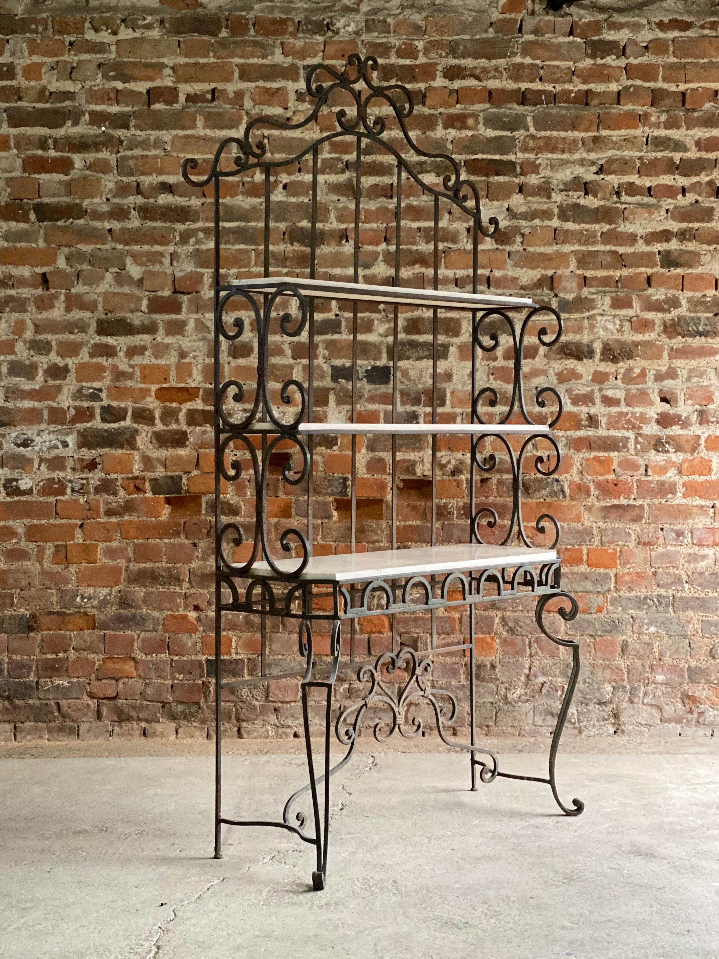 Magnificent French Boulangerie bread display stand, France circa 1890, the cast iron étagère stand having 3 marble lined shelves, ornate iron frame with scrolling detail, the white Carrara marble mounted shelves all raised on tall scrolling