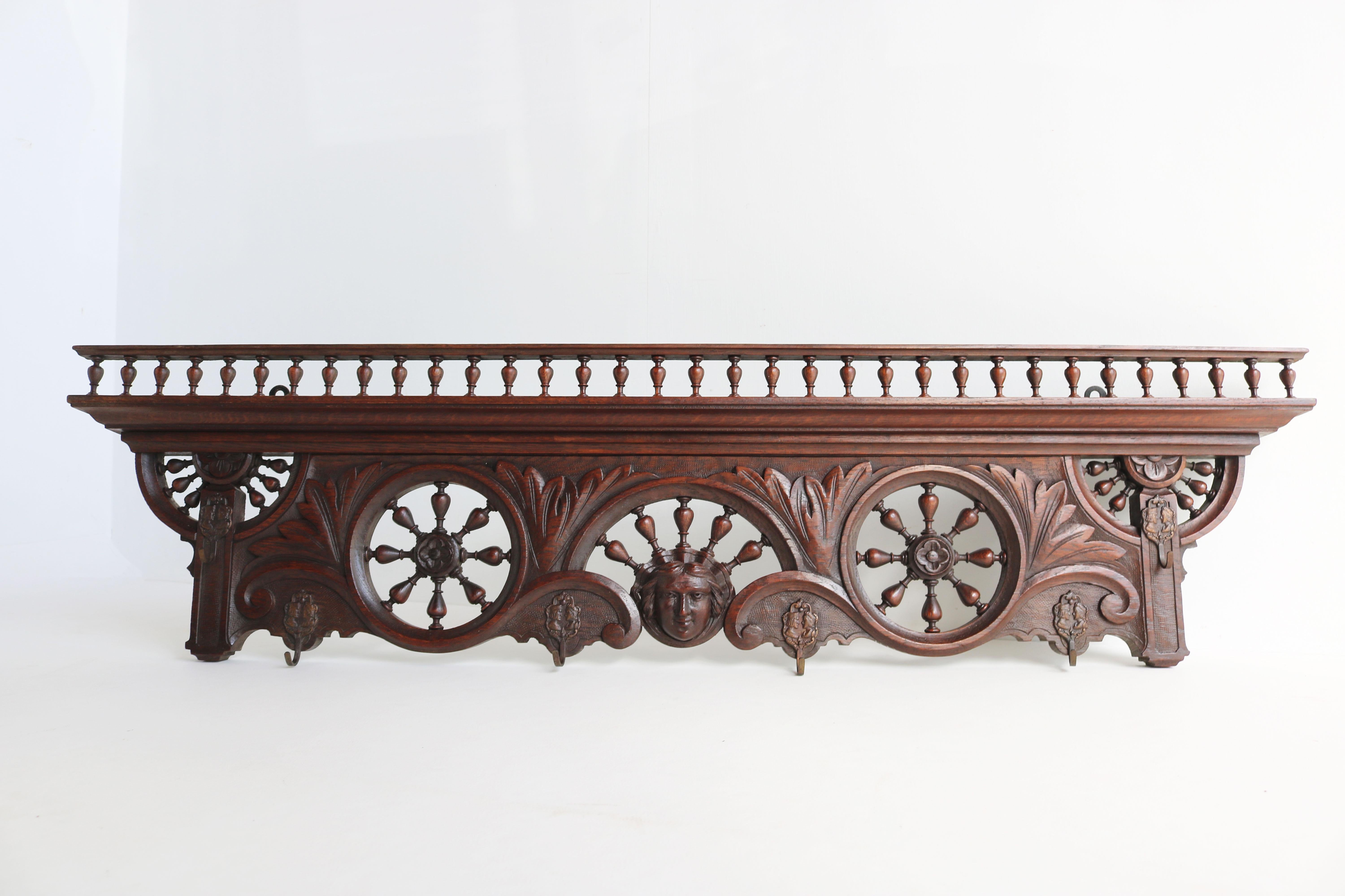 Gorgeous antique French Breton Brittany coat rack from the 19th century France. 
Fully made from hand carved European oak, with marvellous details.
Very rare model with 5 open ship wheel spindles! 
Highly detailed carved face in the centre of the