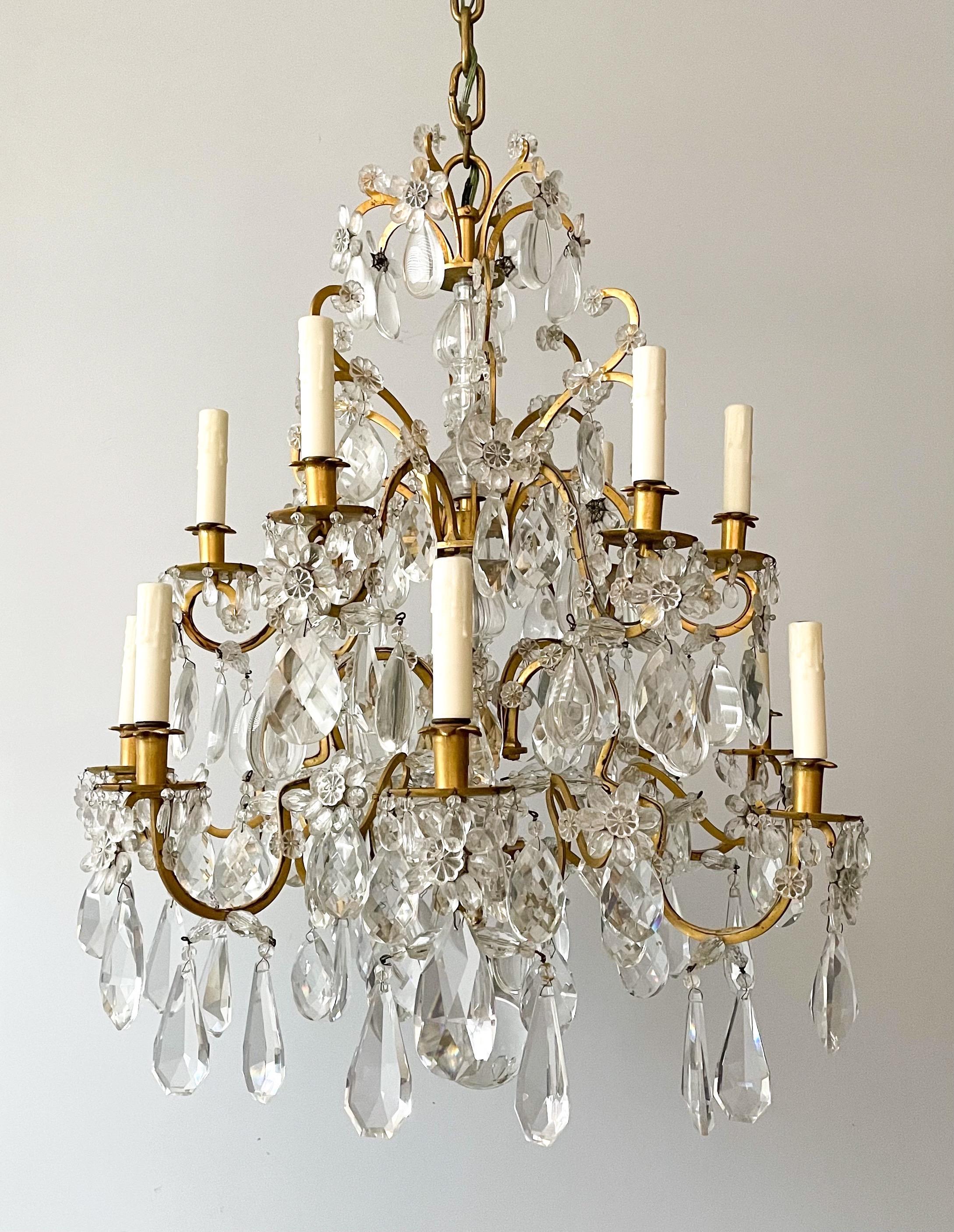 Exquisite, antique French sparkling crystal chandelier in the Versailles style. 

This impressive chandelier consists of a shapely 2-tier bronze frame with a crystal column in its center, it is decorated with an abundance of faceted prisms in a