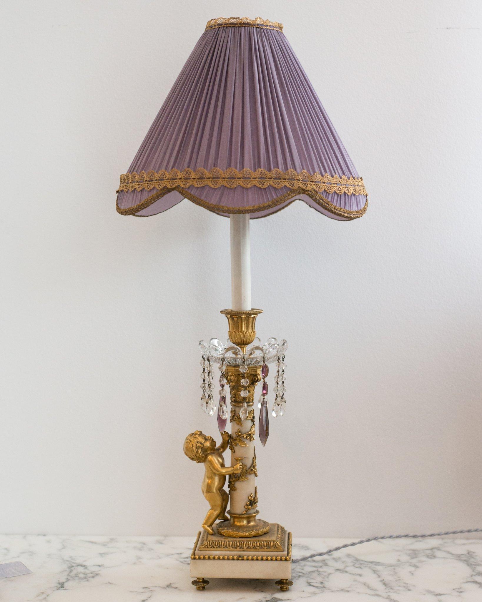 A French Antique marble and bronze lamp with crystal and amethyst drops and a bronze cherub, circa 1880. Newly rewired with a silk cord and custom pleated lavender silk shade with vintage metallic trim.