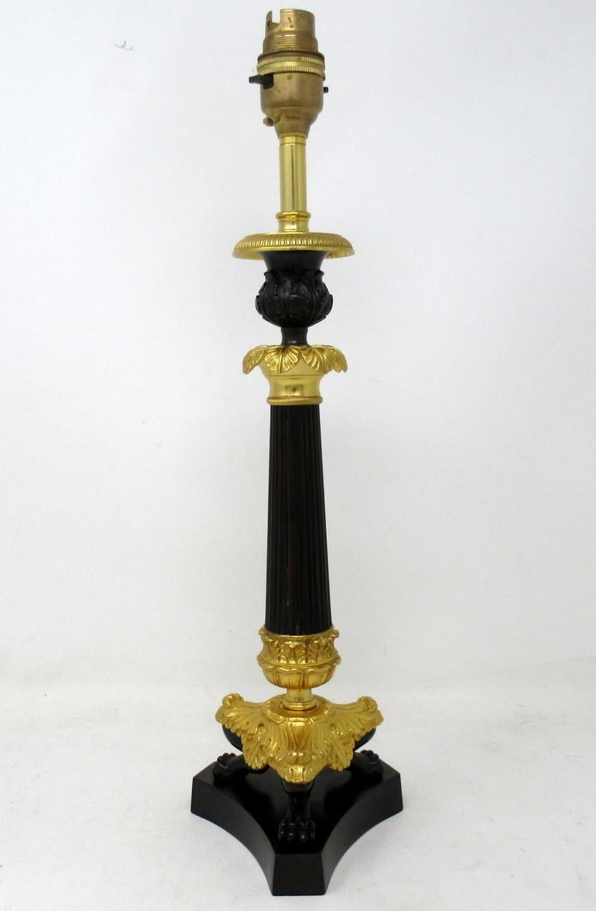 Stunning French Heavy Gauge Ormolu and bronzed single light candlestick of average size proportions, now converted to a Single Electric Table Lamp, with tapering reeded central bronzed column, ending with three very ornate monopodia supports