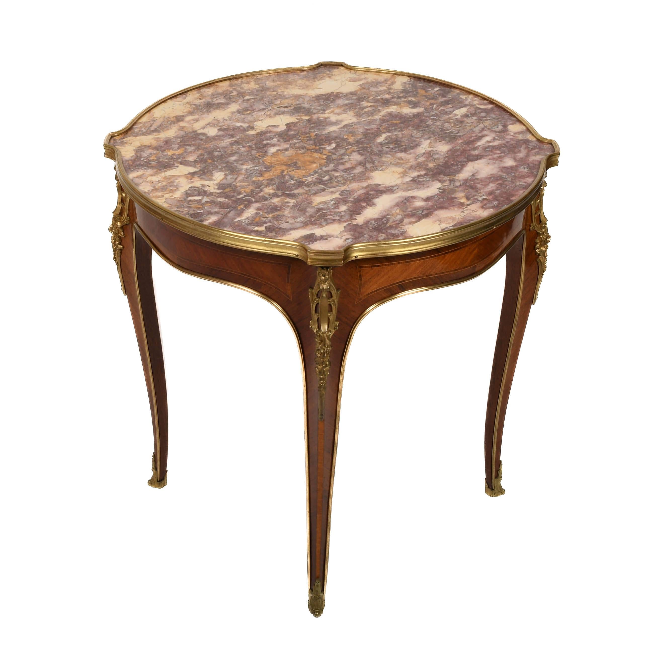 Drenched in old-world elegance, this Antique French Bronze and Rouge Marble Side Table is a regal accent for any refined interior. Its round top showcases swirling shades of crimson, cream, and gold veining. Each detail is a stroke of natural