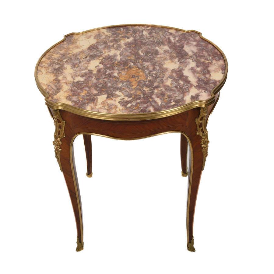 Drenched in old-world elegance, this Antique French Bronze and Rouge Marble Side Table is a regal accent for any refined interior. Its round top showcases swirling shades of crimson, cream, and gold veining. Each detail is a stroke of natural