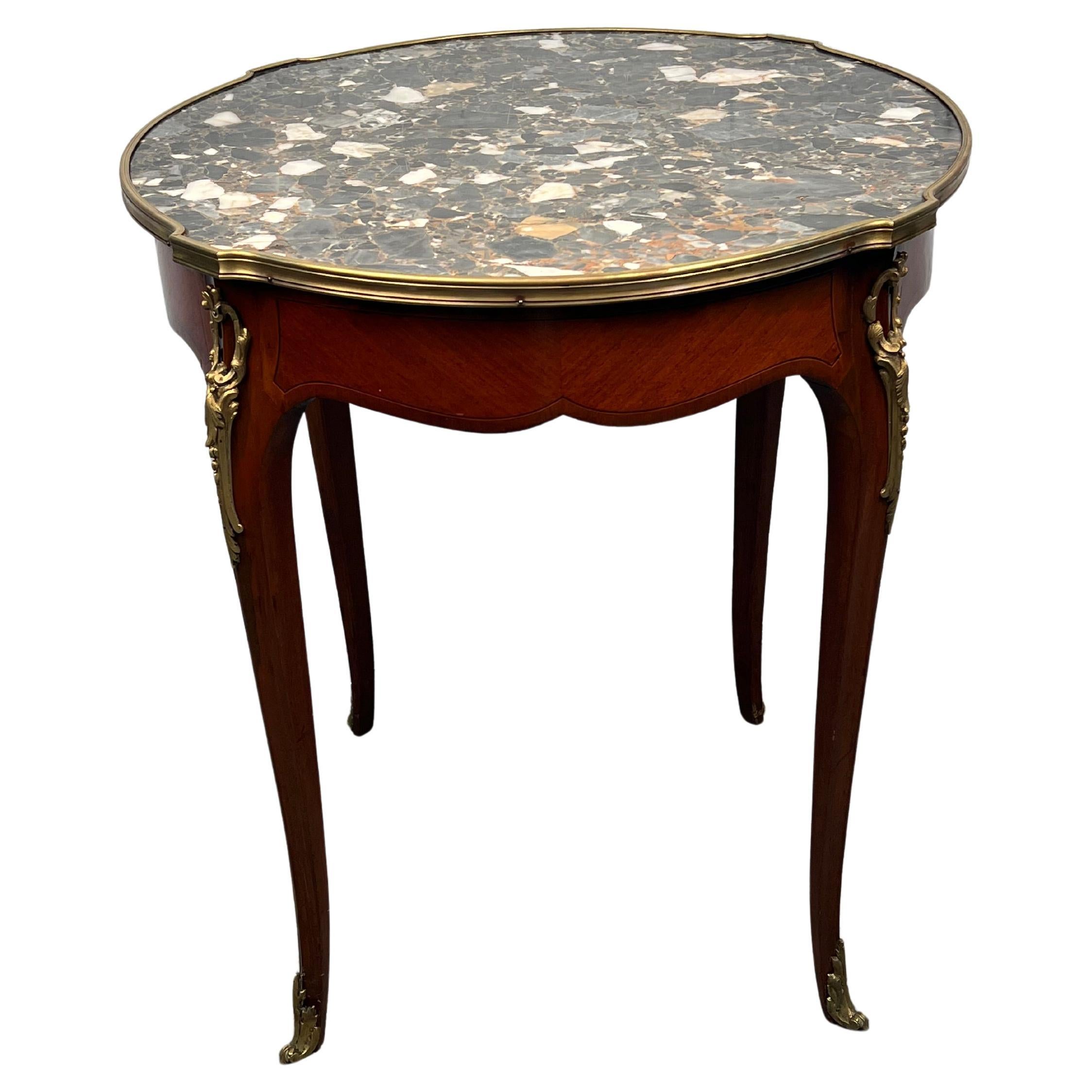 Spoil your living room with this unique French side table, crafted in the Louis XV style. The brass trim and ornamentation is in great shape, and the marble will subtly accentuate any interior. 

Please confirm item location with seller (NY or NJ).