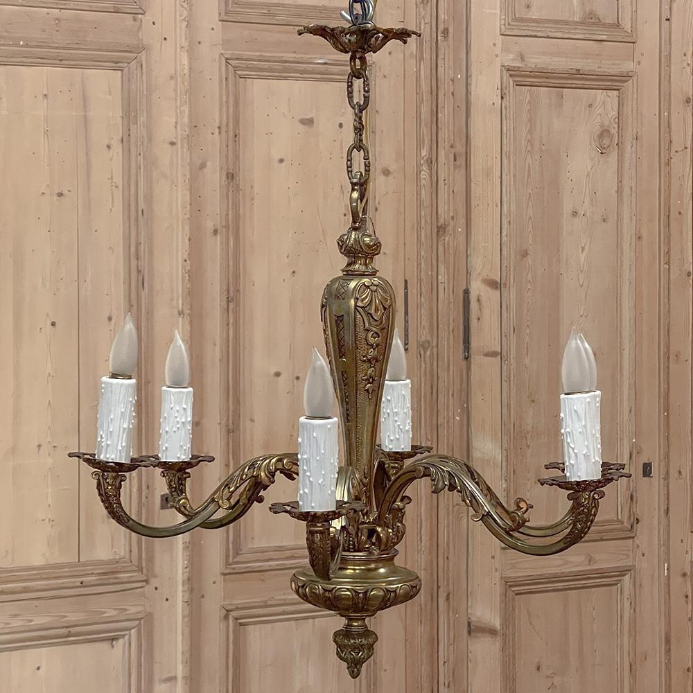 Antique French Baroque Mazarin bronze chandelier represents the stately elegance that defines the Louis XIV style, and was meticulously cast in solid bronze then polished for a lustrous, golden effect. Several links of the original chain, plus the