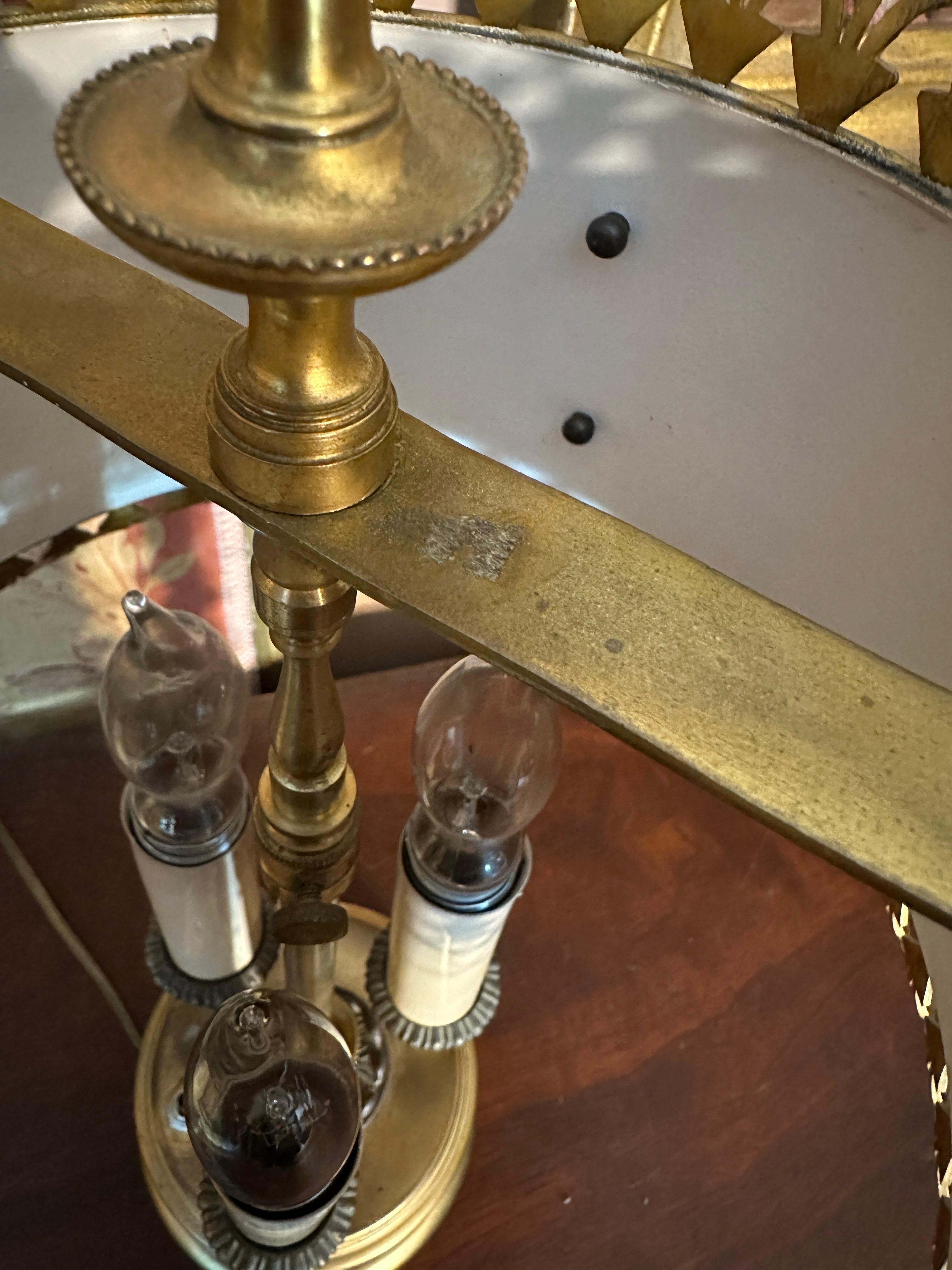 Absolutely fantastic round bronze base with a very art deco relief, in the round of the base. 

Shade is thick brass with brass ornamention, no detail left unconsidered. 

Switch appears to be added, unsure of exact age but this may have been a