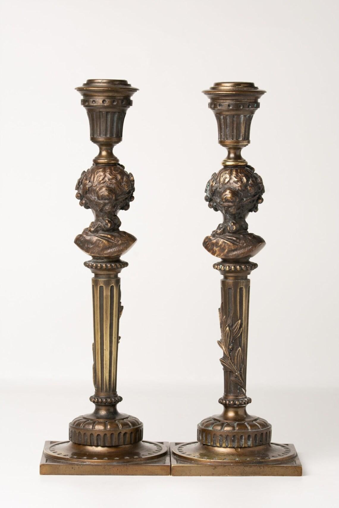 Antique pair of French bronze figural candlesticks depicting Bacchante maidens ( Female followers of Bacchus were called Bacchante. Their heads are beautifully decorated with wine leaves and grapes with their hair up. Their heads are placed on