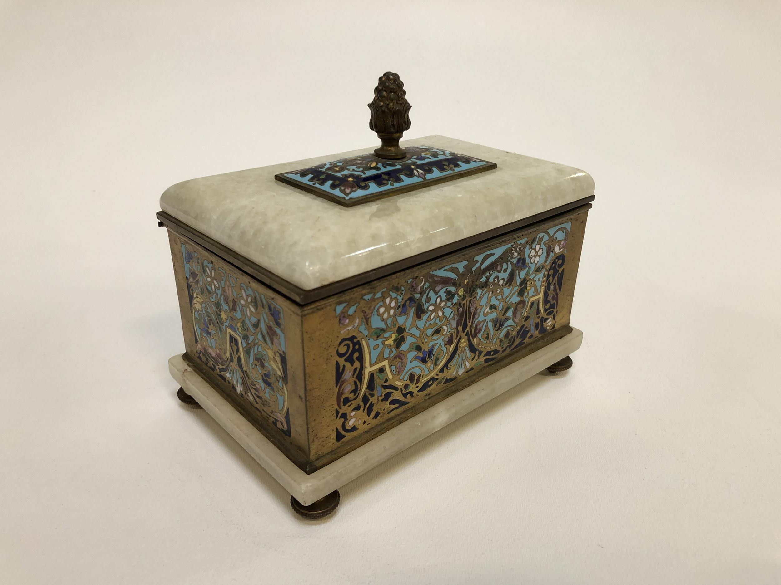 This is a beautiful ornately designed bronze cloisonné box that features an alabaster lid and base. This base allows light to enter from the bottom when the box is open, which is a lovely feature. The presence of alabaster also makes this piece