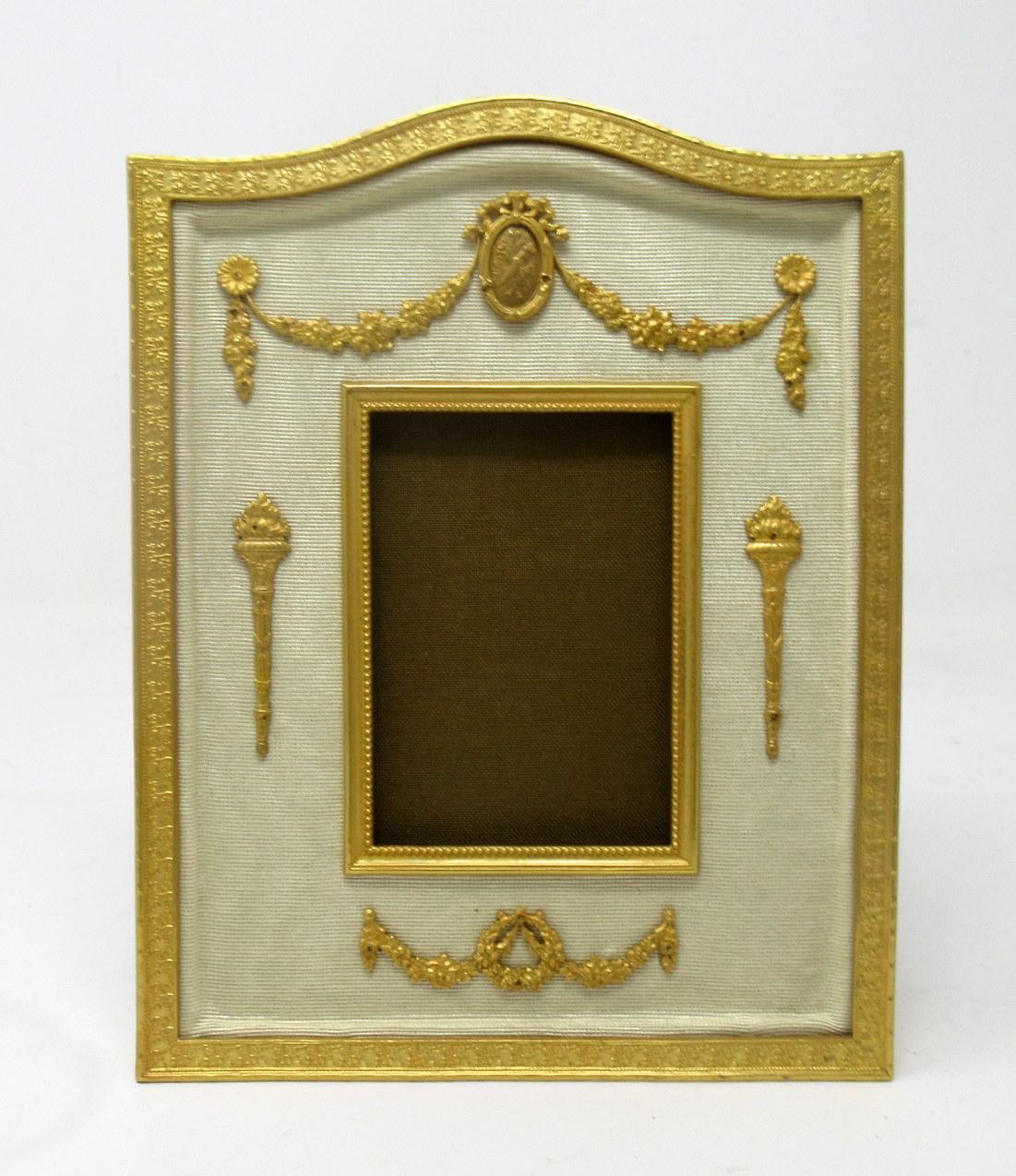 A stunning French heavy gauge Ormolu standing or wall hanging Photo Frame of medium proportions and outstanding quality, mid to late Nineteenth century. 

The arched top ormolu embossed frame enclosing a plain portrait shape photo framed inset