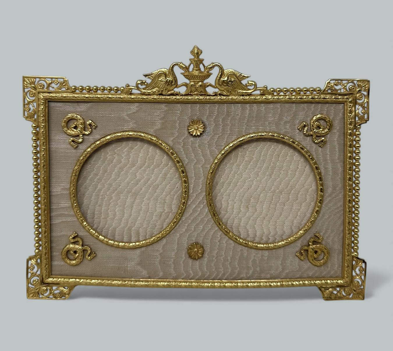 A Stunning French heavy gauge Ormolu Standing Photo Frame of medium proportions and outstanding quality, mid to late Nineteenth Century. 

The rectangular outline ormolu frame enclosing twin circular frames suitable for portraits surrounded with