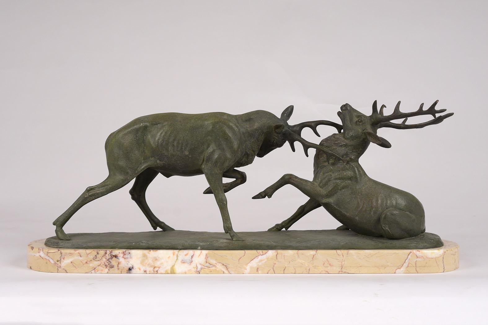 This antique French bronze statue depicting two fighting elk is in great condition with original patina this statute sits on its original oval marble base. This beautiful French sculpture is ready to be used for years to come.