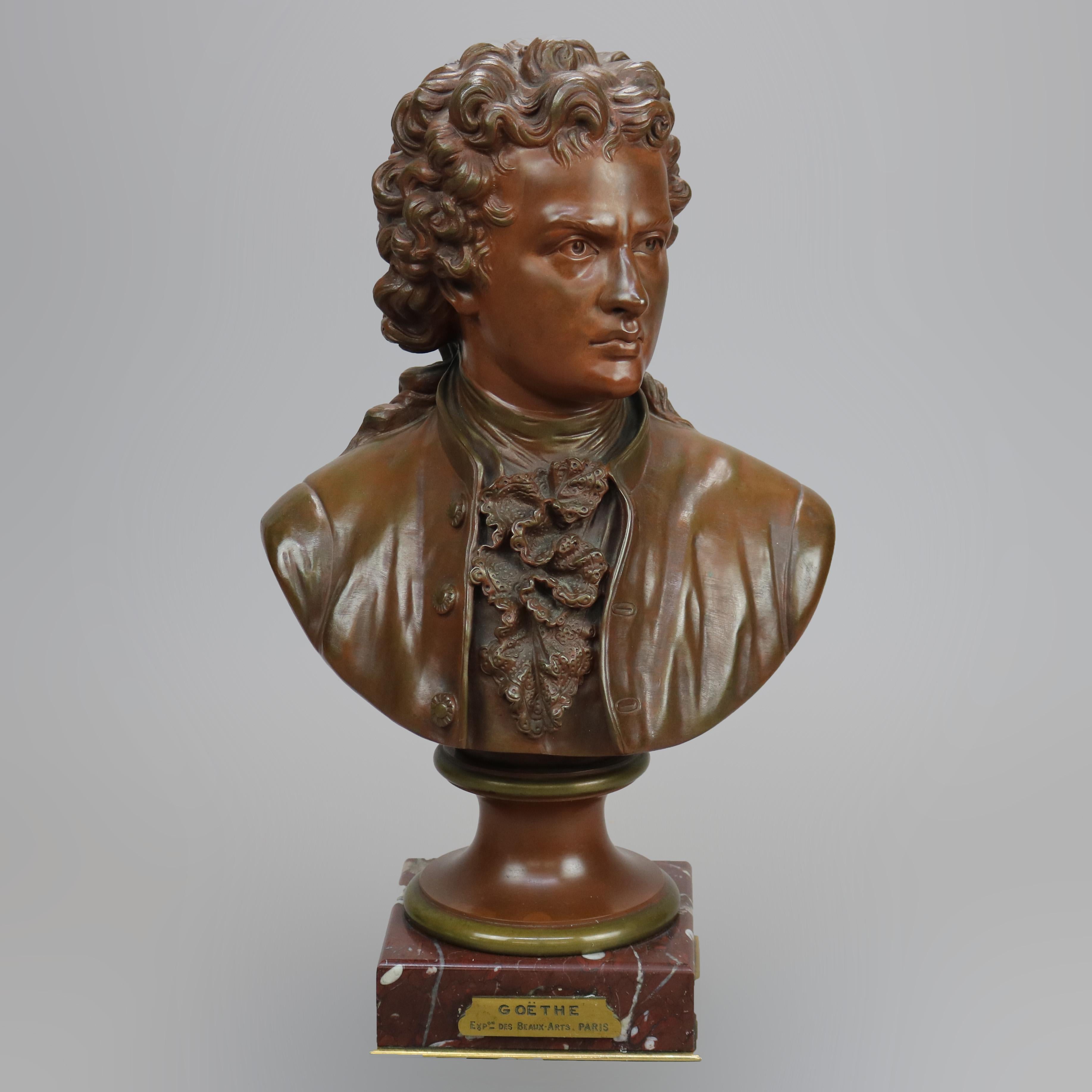 An antique French bust sculpture offers cast bronze portrait of Johann Wolfgang von Goethe seated on rouge marble base having identifying plaque 