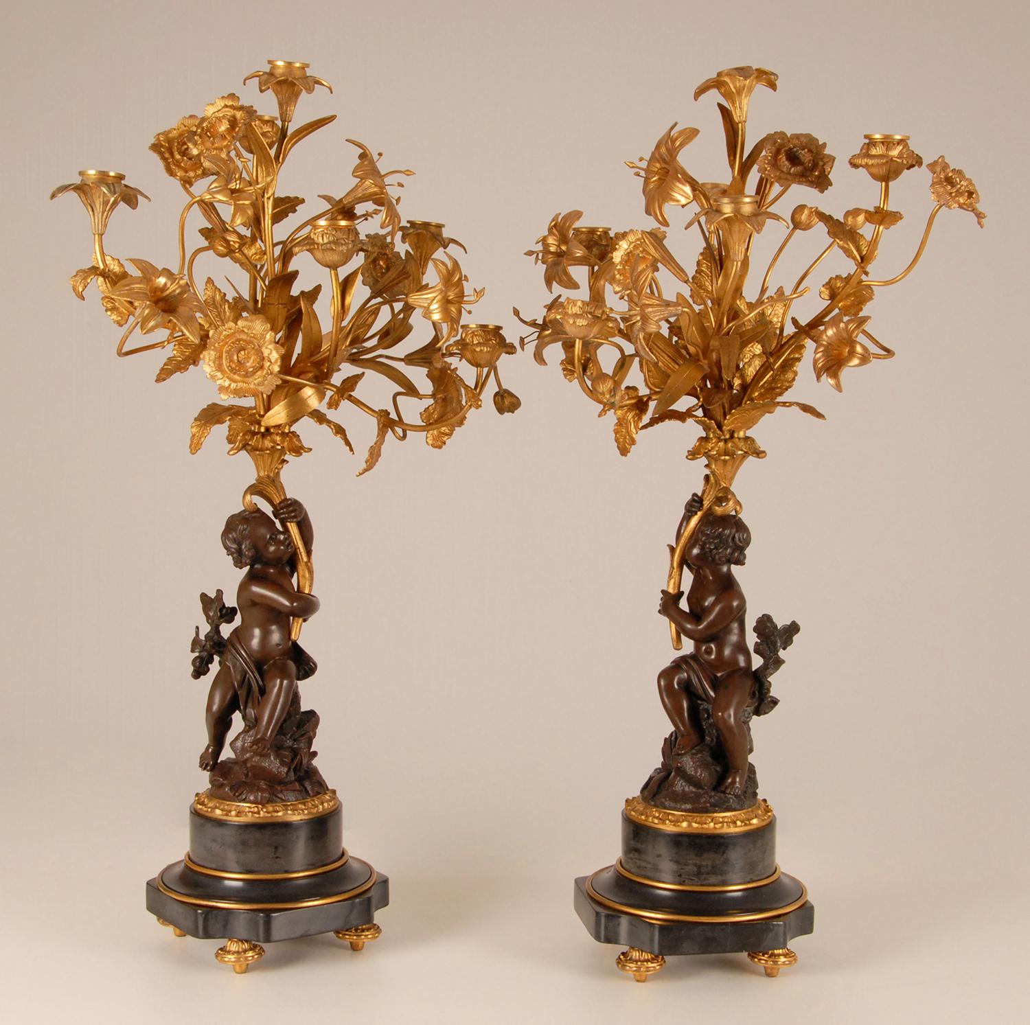 Antique French gilt bronze candelabras Putto holding a bunch of flowers
Antique French gold gilded bronze 6 light Candelabra on a marble base - a pair
Material: Gold gilded bronze, patinated bronze, marble
Design: In the manner of Claude Michel