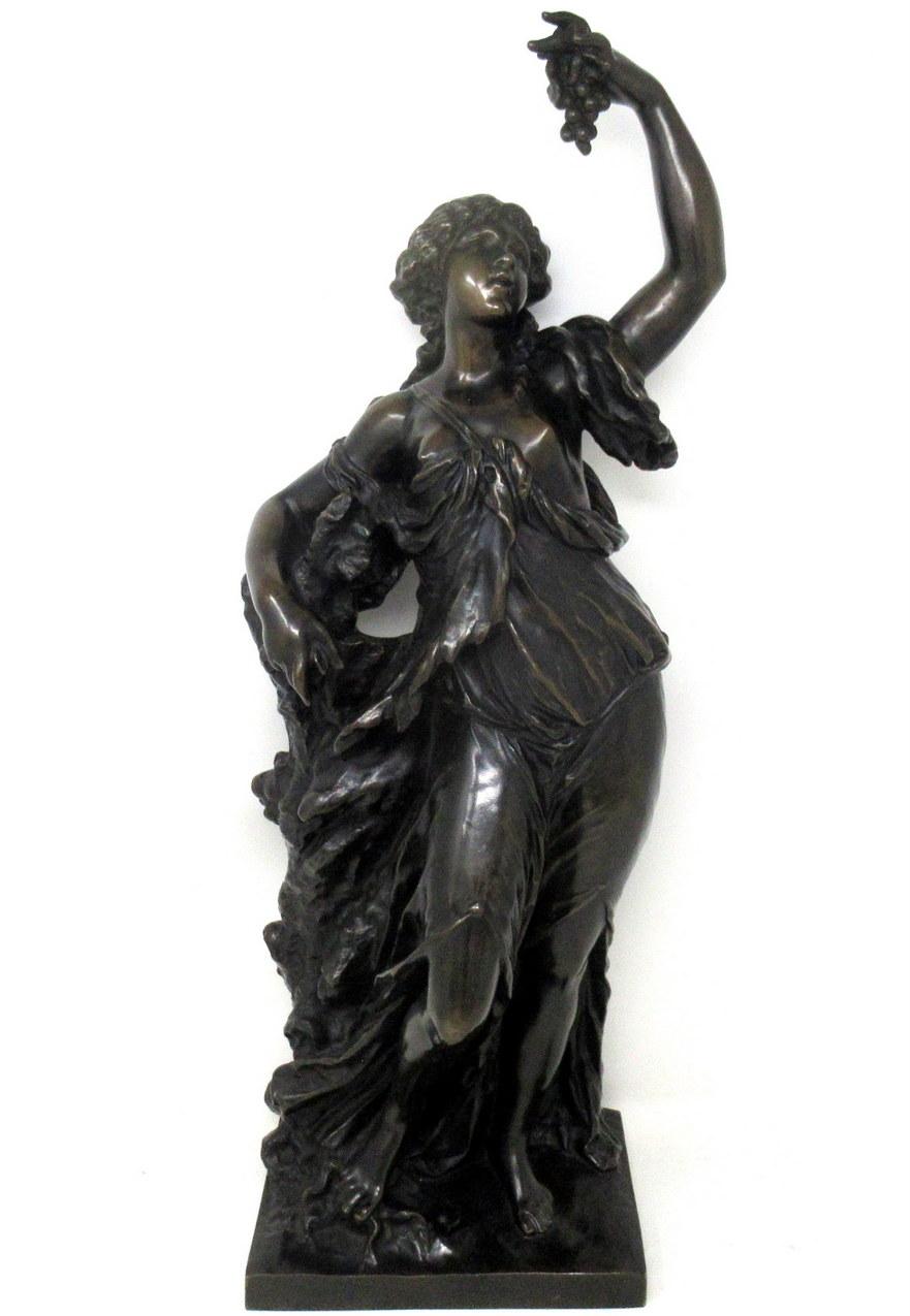 An exceptionally well cast example of a Classical French patinated Bronze Figure of a young woman holding a bunch of grapes depicting “Allegory of the Vine” after Claude Michel Clodion (1738-1814) in nice dark patination. Mid Nineteenth Century.