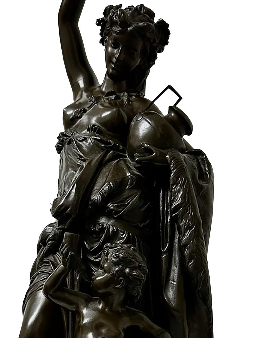 Statue antique en bronze représentant une jeune fille et un putti sur une base ronde en marbre. Dans le style de A. Carrier Belleuse. Circa 1850 à 1890, France. Non signée.