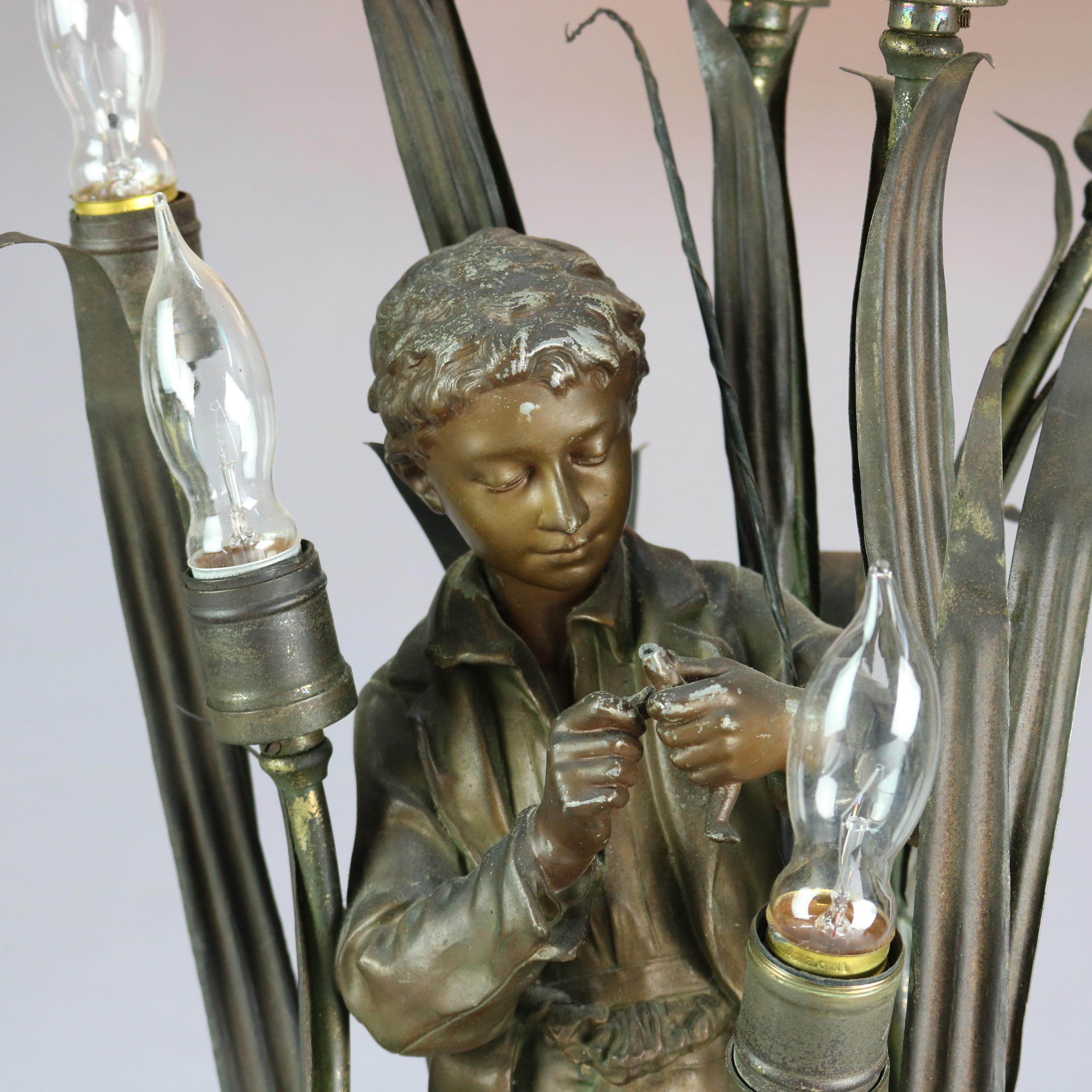An antique figural six-light newell post lamp offers bronzed cast metal sculpture titled Le Pecheur depicting a boy fishing among reeds or cattails, c1890

Measures: 28