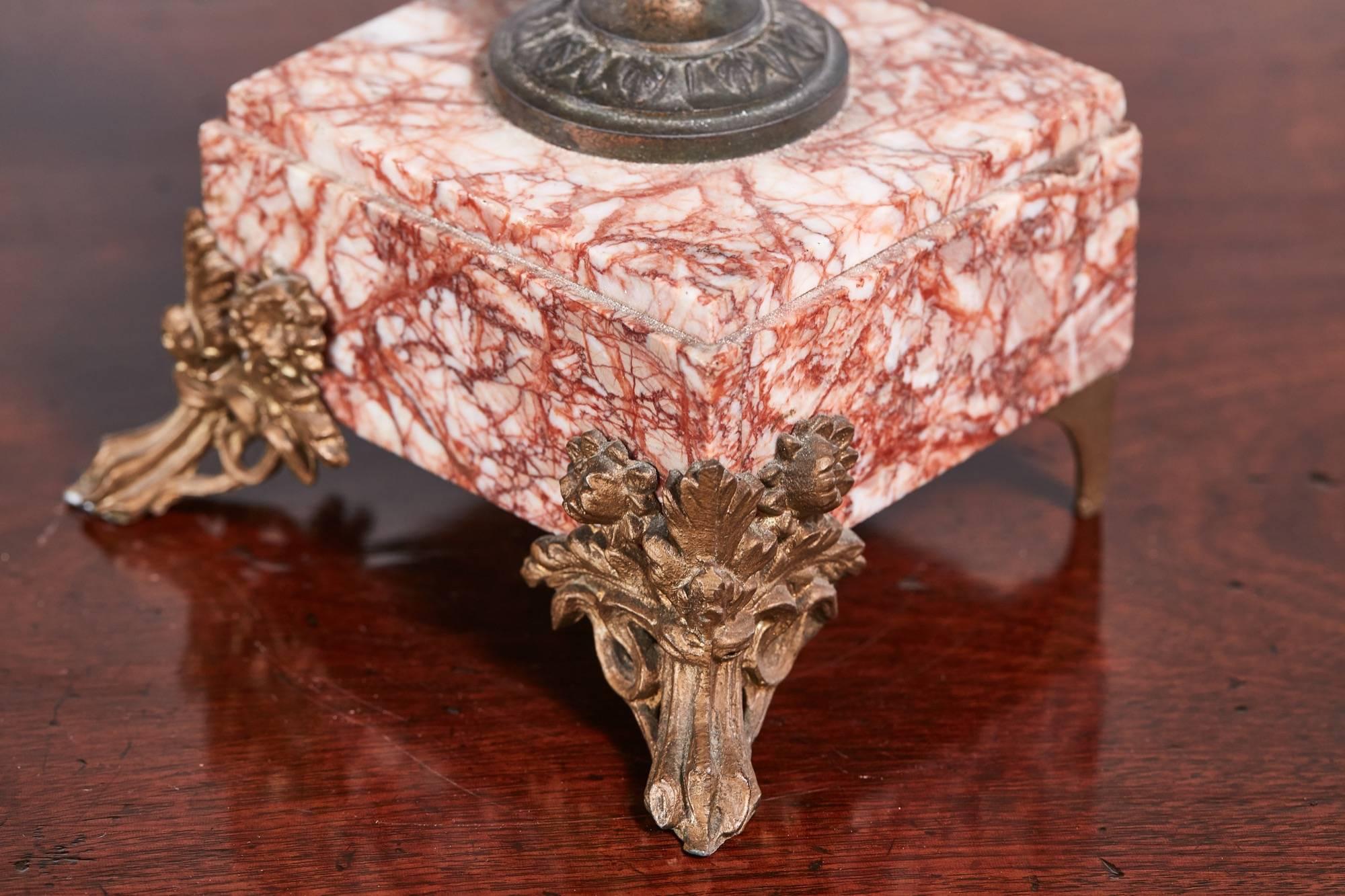 Antique French bronzed spelter and pink marble clock garniture, the clock mounted with a figure of a girl representing the harvest, the dial with an Arabic numeral chapter ring signed Lecarpentier, together with a pair of matching