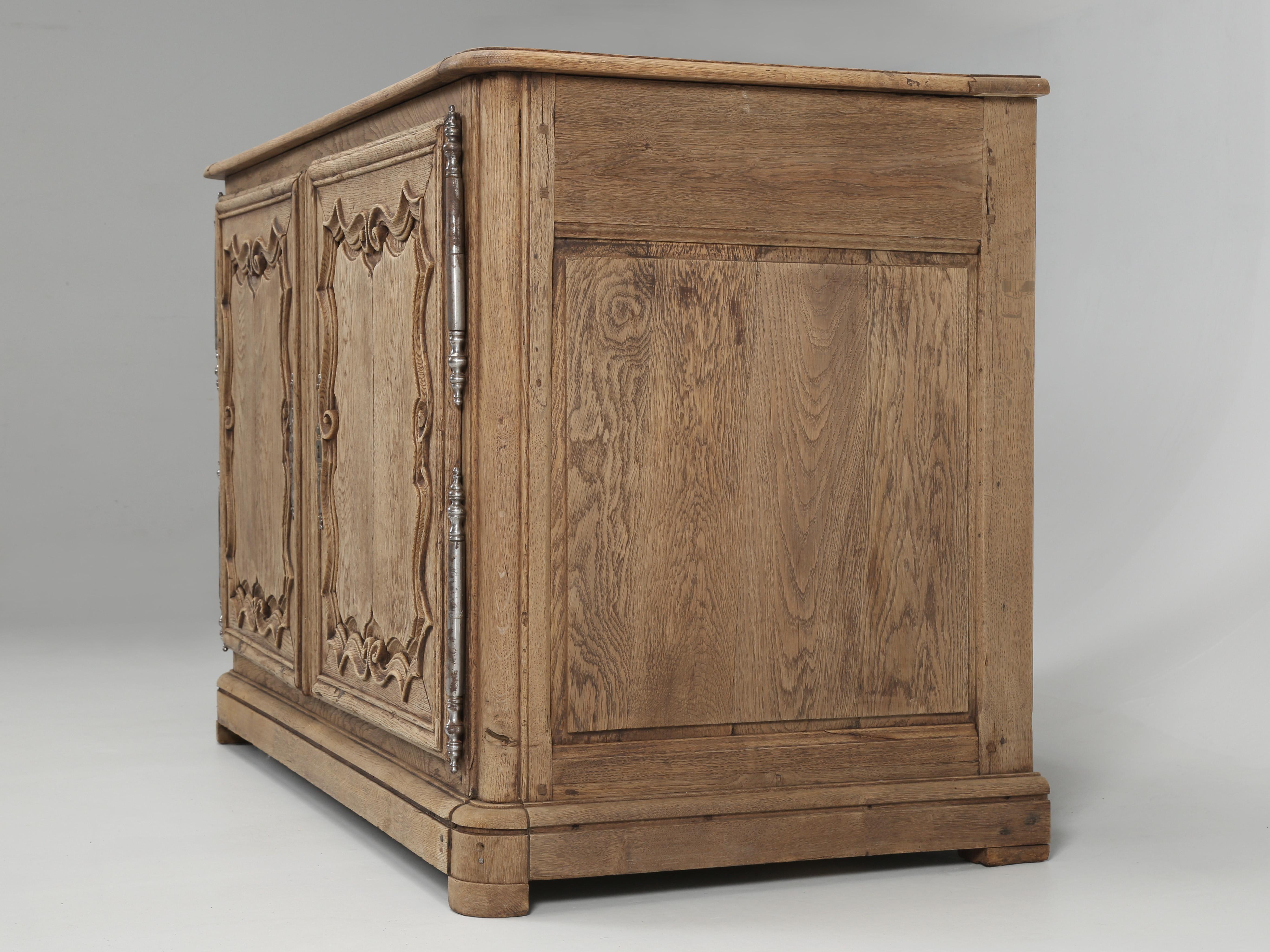 Antique French buffet that dates back to the 1700’s and it has a most unusual feature, the top opens, which we have never witnessed before when combined with conventional doors. When you look closely at the hinges for the lid, you’ll notice that