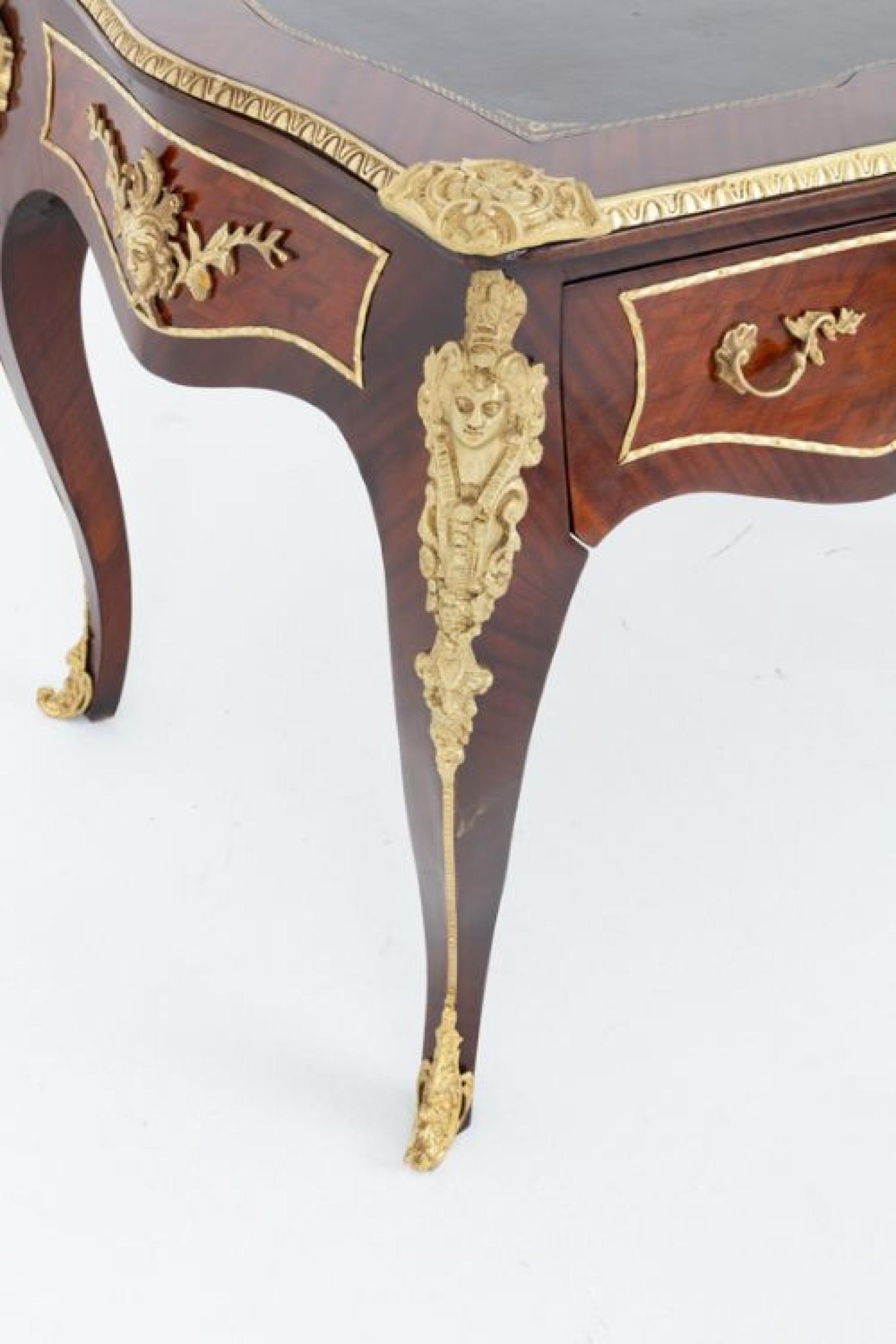 This rather impressive French bureau plat stands upon shaped legs Circa 1920
Featuring 3 working drawers to the front with 3 faux drawers to the rear with wonderful decorative ormolu handles
The top of the bureau plat features a leather writing