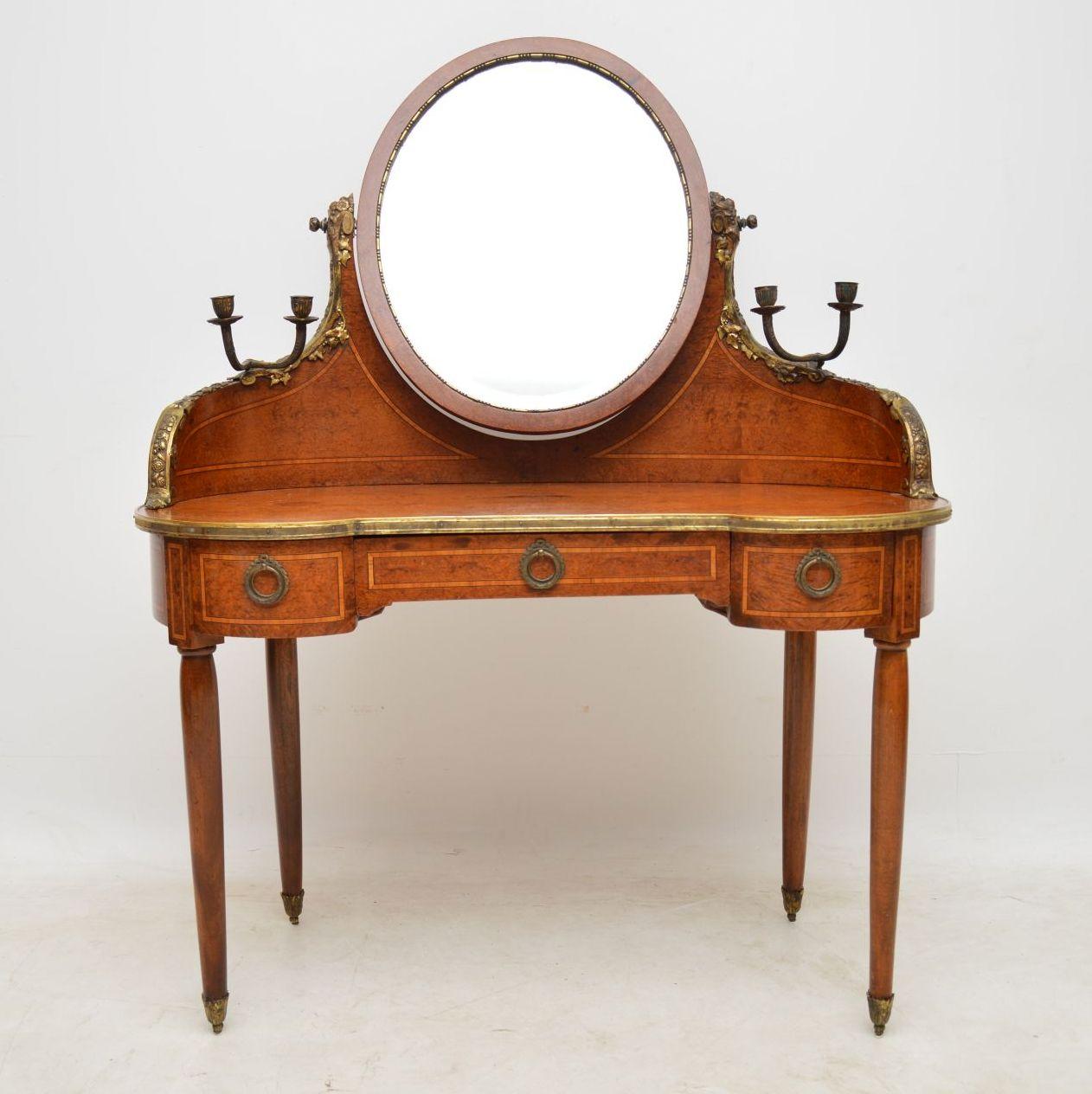 This stunning antique French dressing table is very high quality and has fabulous features. The wood looks like a very tight burr walnut, but it could be something more exotic like Amboyna. We have had it polished, however there is natural ageing