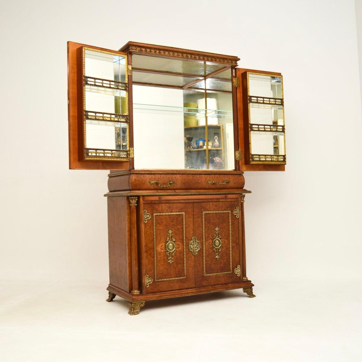 An absolutely stunning antique French burr walnut drinks cabinet, dating from around the 1920-30’s.

This is of outstanding quality and has lots of nice features. The burr walnut has gorgeous colour tones and grain patterns, this is adorned with