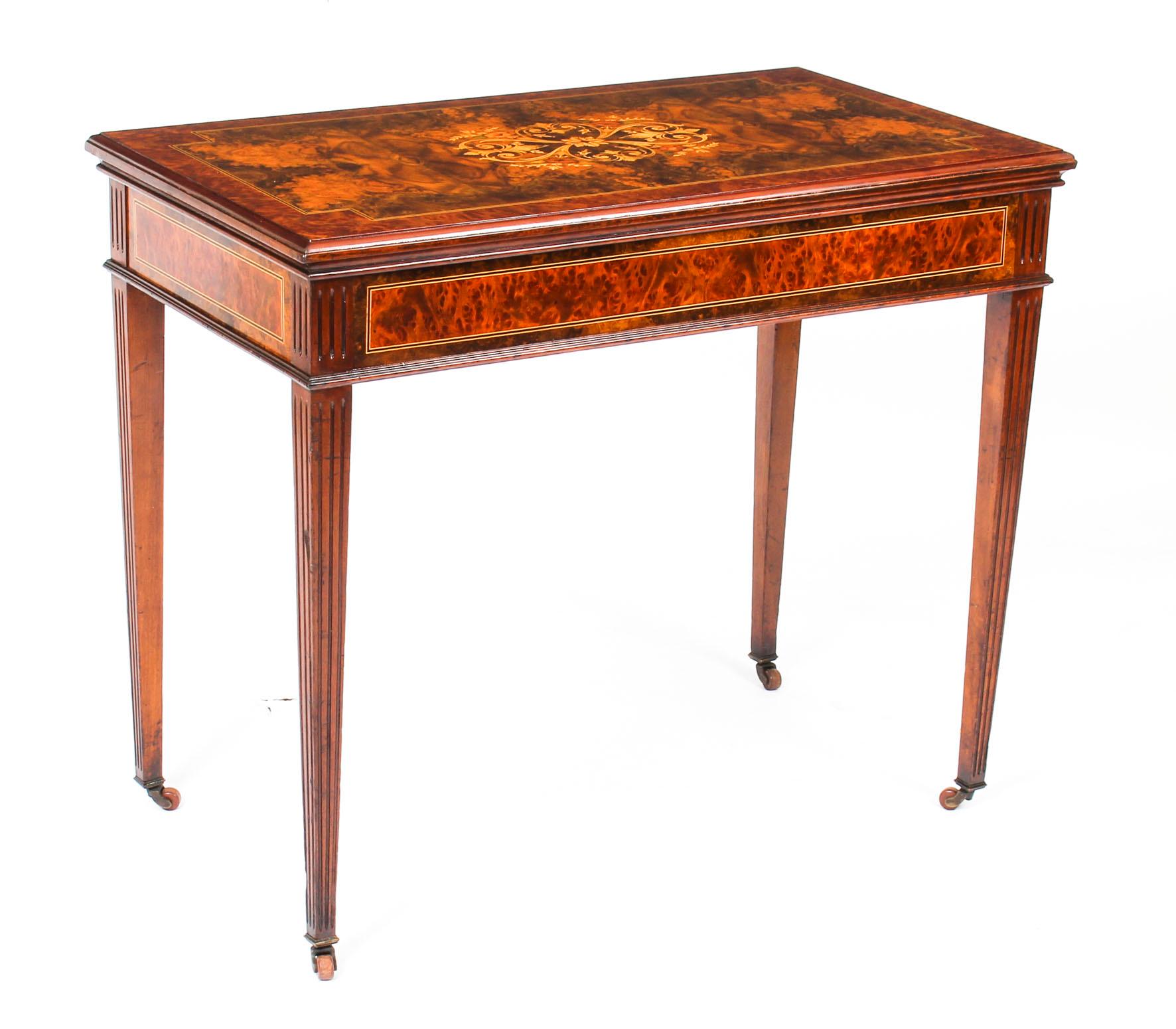 This is a fine antique French burr walnut and marquetry games table, stamped Roulette Francaise, Marque Deposee, circa 1860 in date.

The lift up lid is decorated with foliate and floral marquetry, the reverse features an ebonised and satinwood
