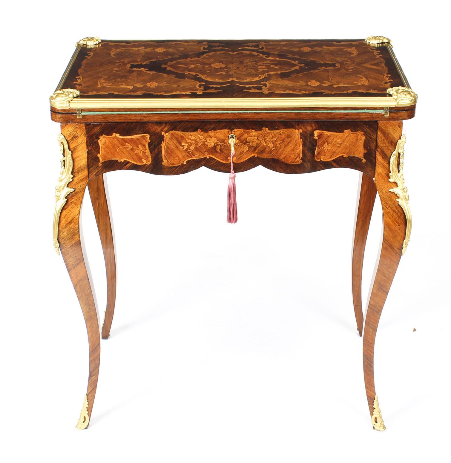 This is a rare late 19th century antique French ormolu mounted metamorphic burr walnut and floral marquetry card table, writing table and dressing table.

The shaped burr walnut top has walnut banding encompassing exquisite floral marquetry