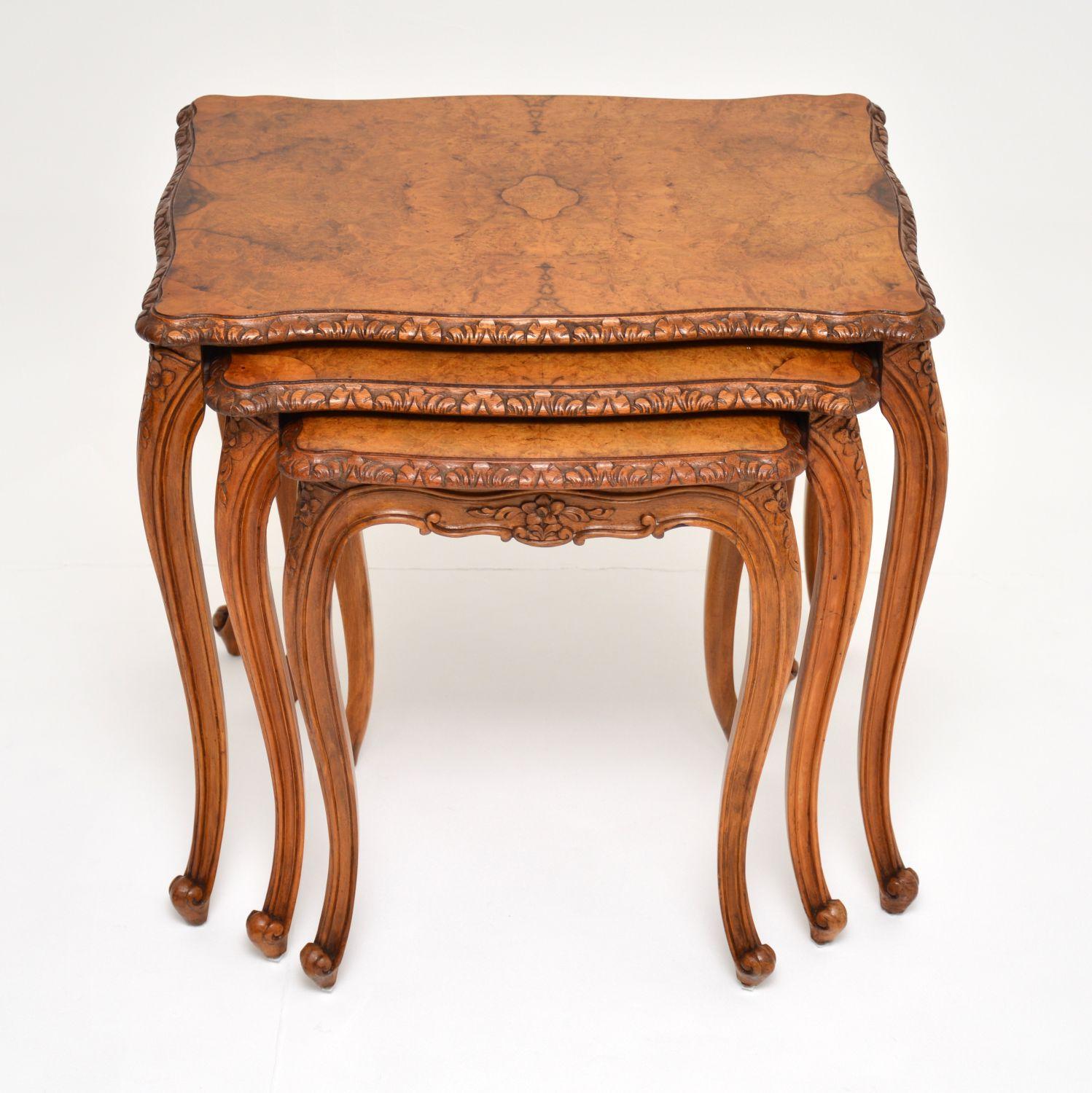 A stunning antique burr walnut nest of three tables. This is in the Classic French style, it dates from circa 1920s-1930s period.

The top has beautifully patterned burr walnut veneers, this has a serpentine shape design, and has finely detailed