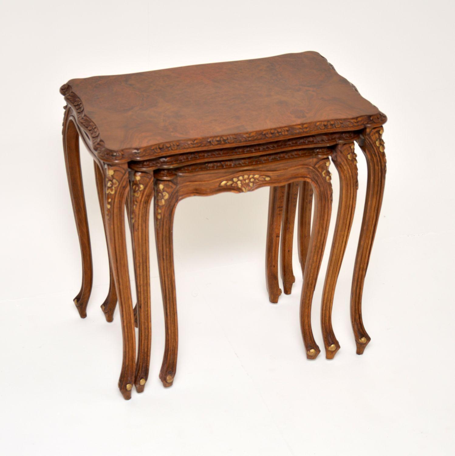 A beautiful antique French style walnut nest of tables with burr walnut tops, dating from around the 1930’s period.

The quality is superb, they are beautifully constructed with crisp floral carving and lovely serpentine shaped tops. The burr walnut