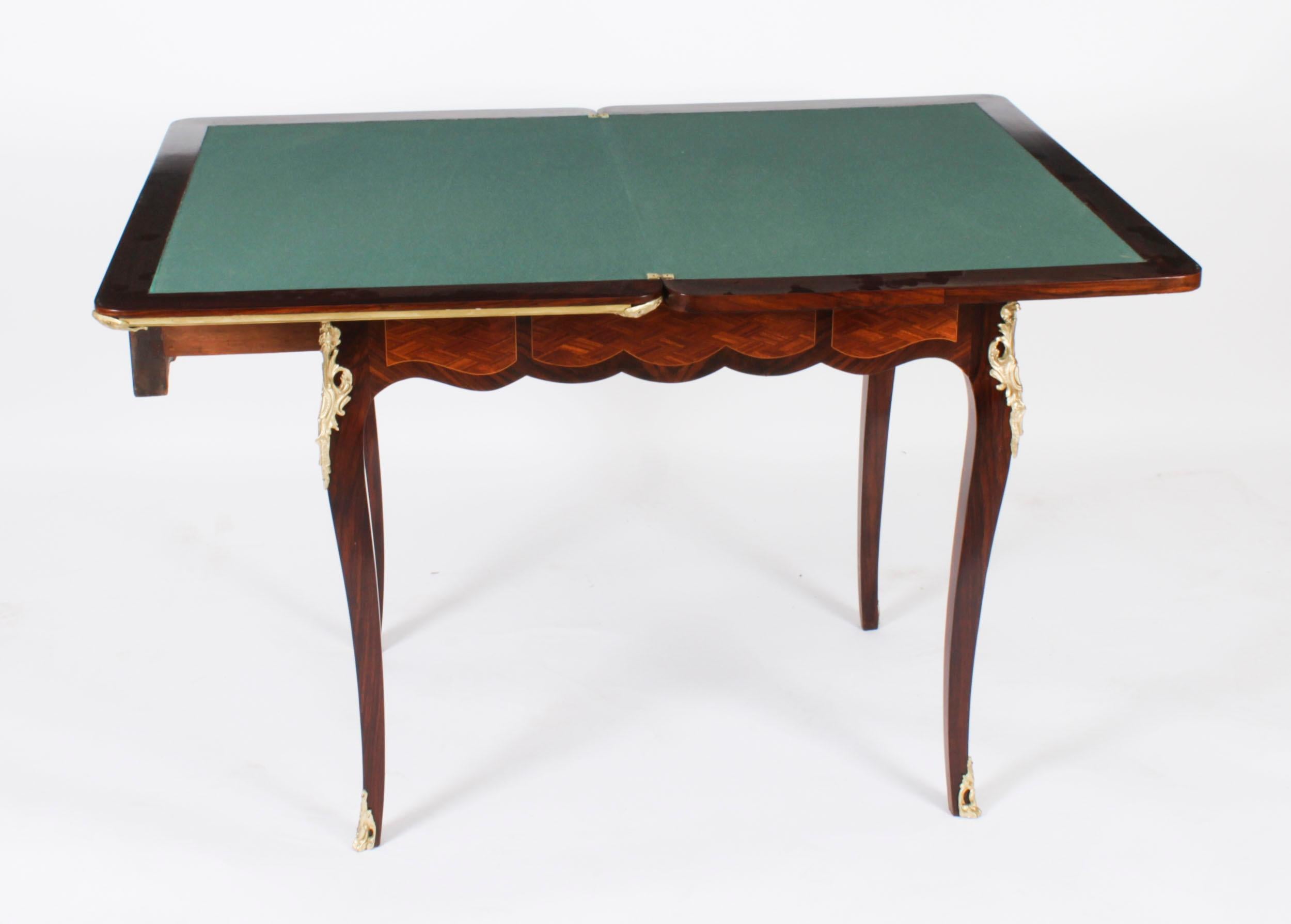 A truly fabulous antique French parquetry turnover top games table, circa 1880 in date.

The top with ormolu banded edge, the parquetry decoration exhibits a stunning array of exotic woods.

The attractive ormolu mounts only enhance the overall