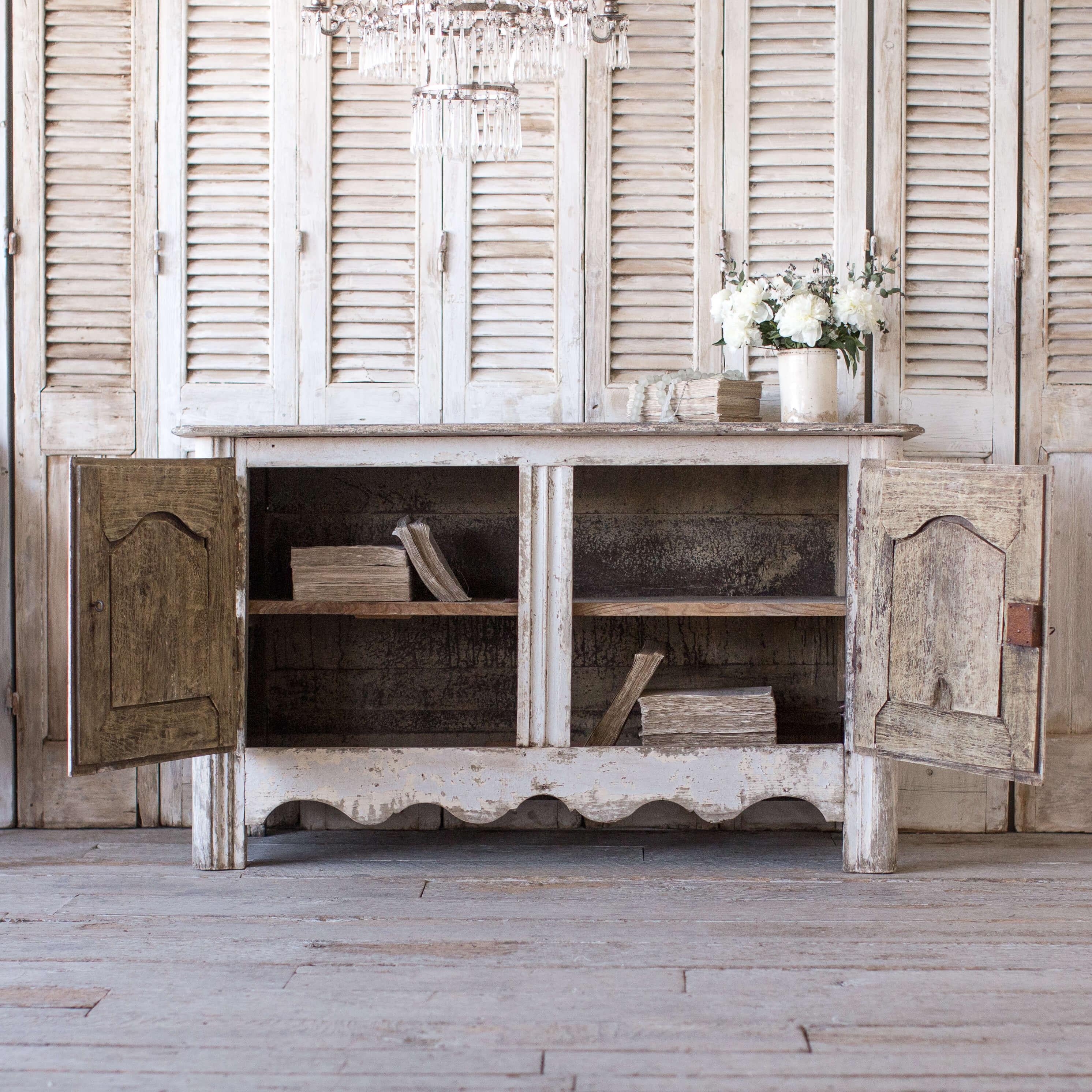 Gorgeous two-door cabinet from the southwest of France. This piece has amazing old hardware and unusual Quatrefoil carving on doors as well as beautiful scrolling base details. A true stand out piece.